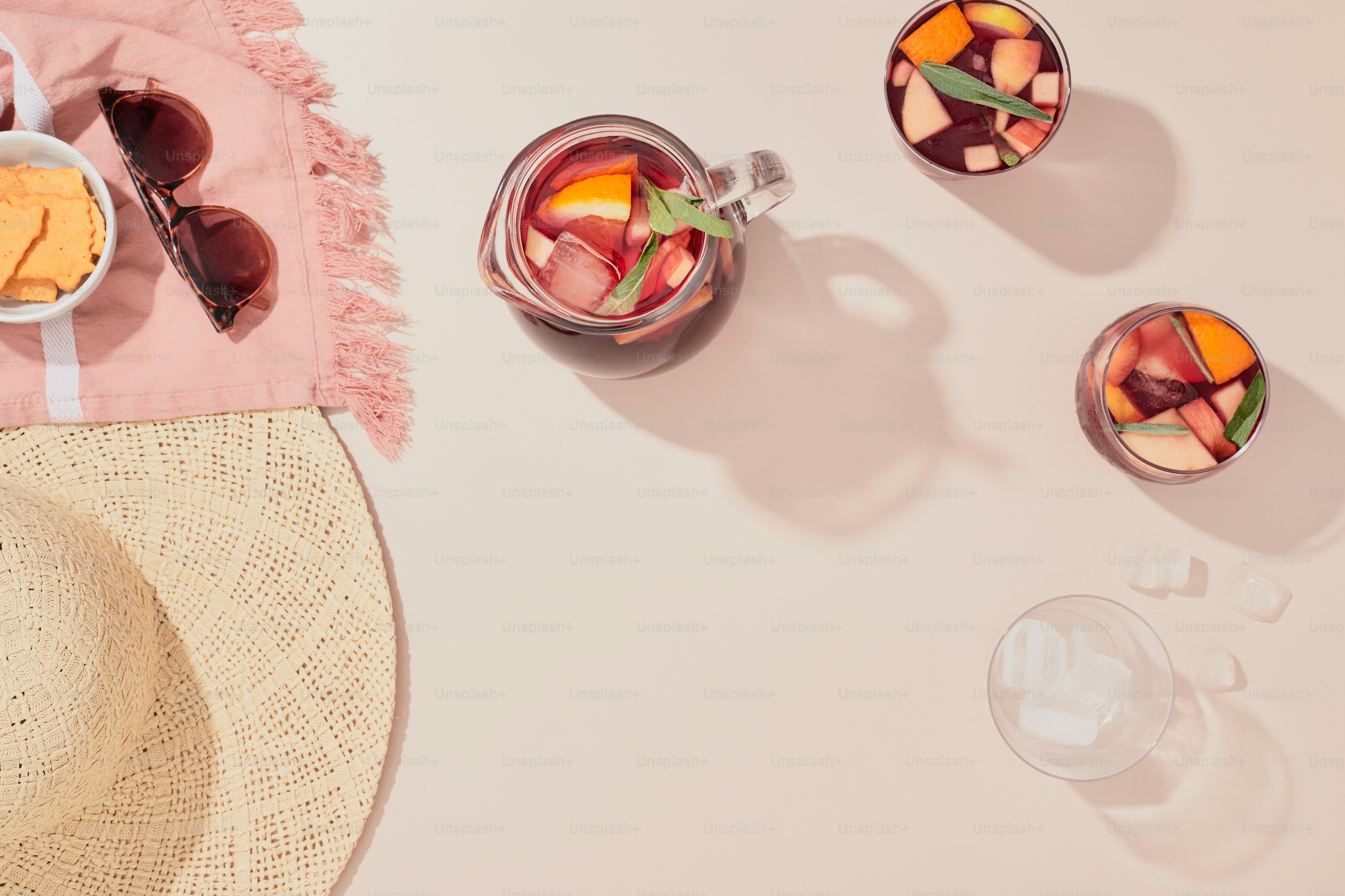 A table topped with glasses and a straw hat