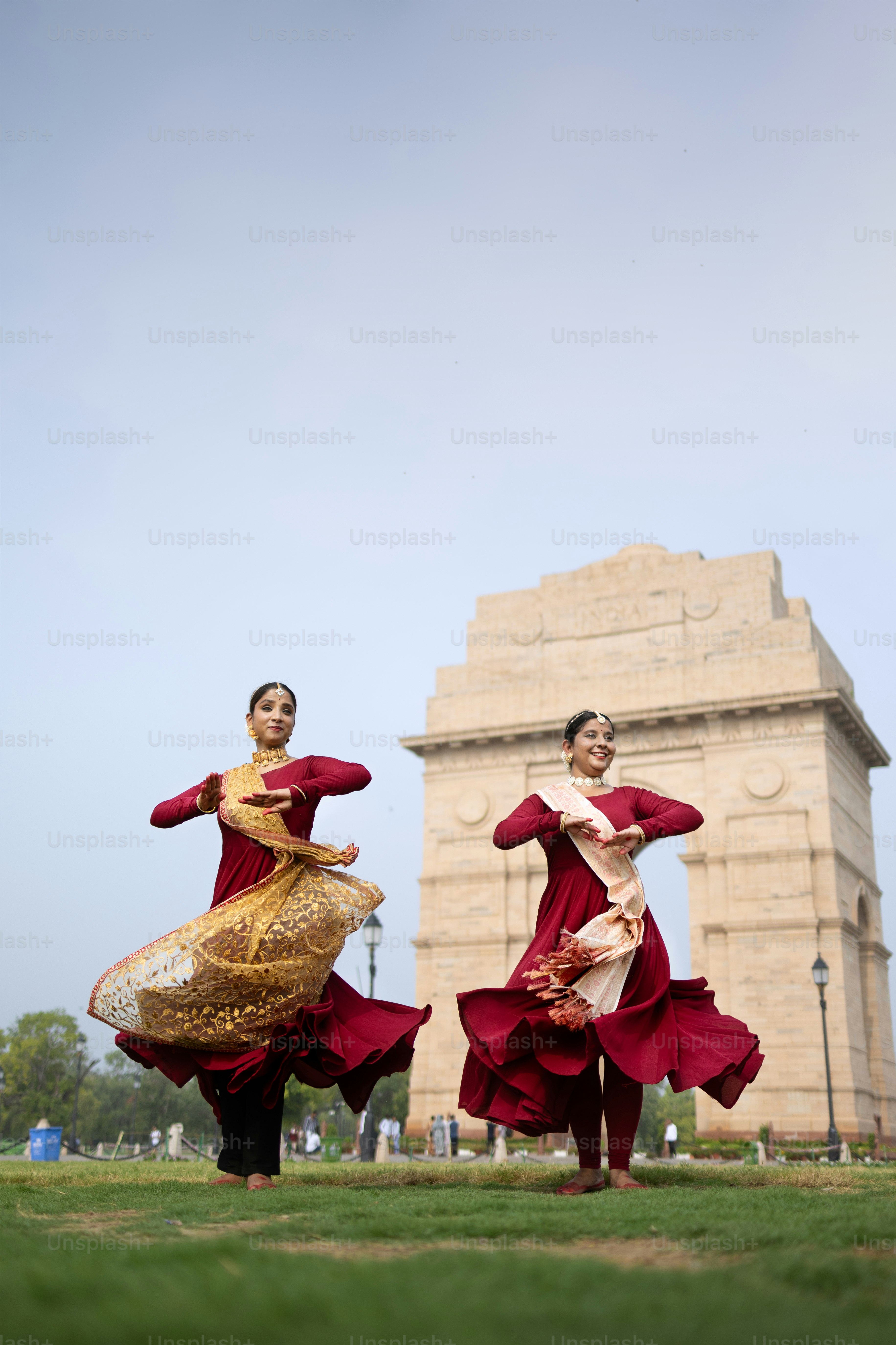 A couple of people that are standing in the grass