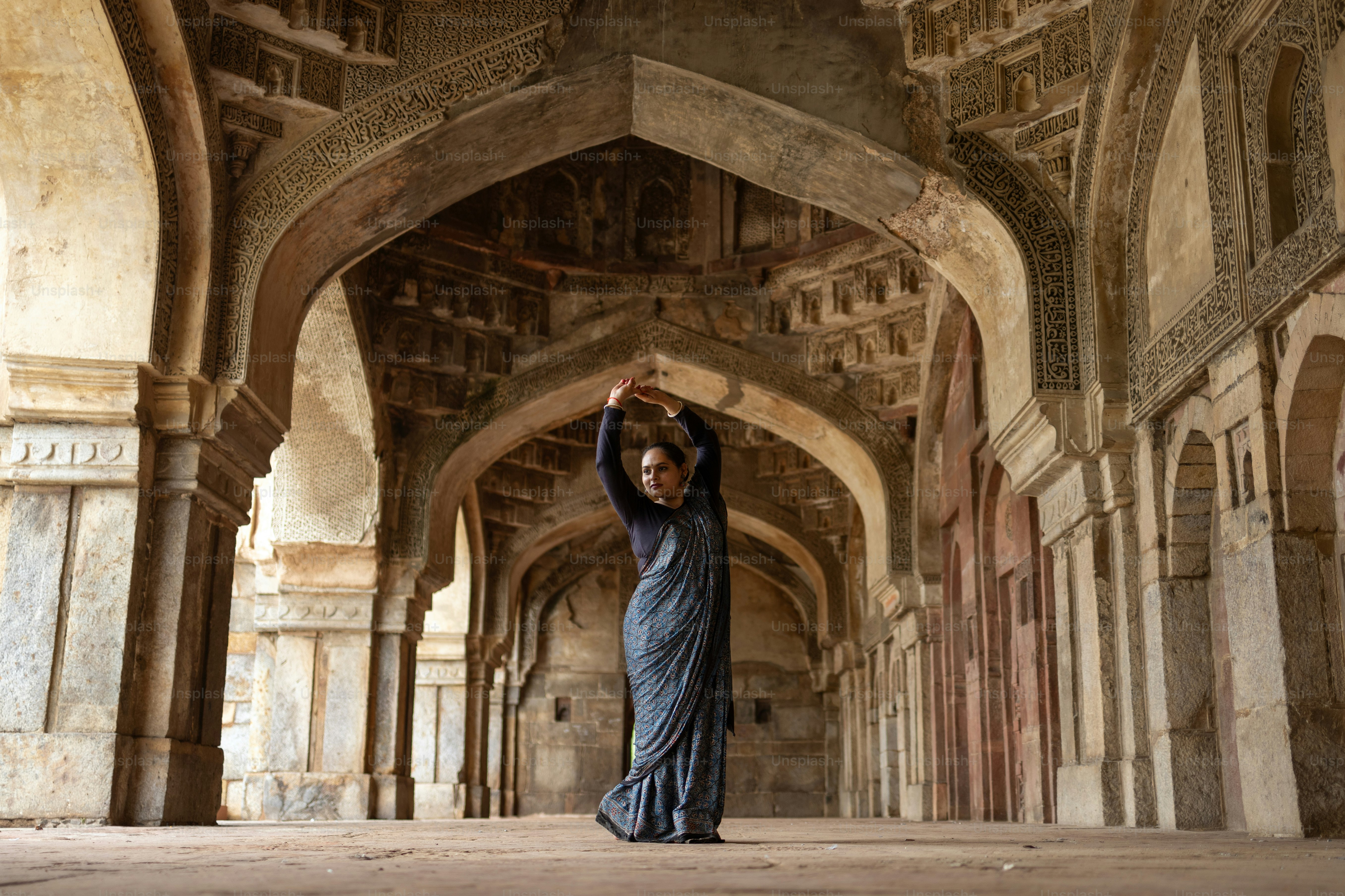 A woman is standing in a large building