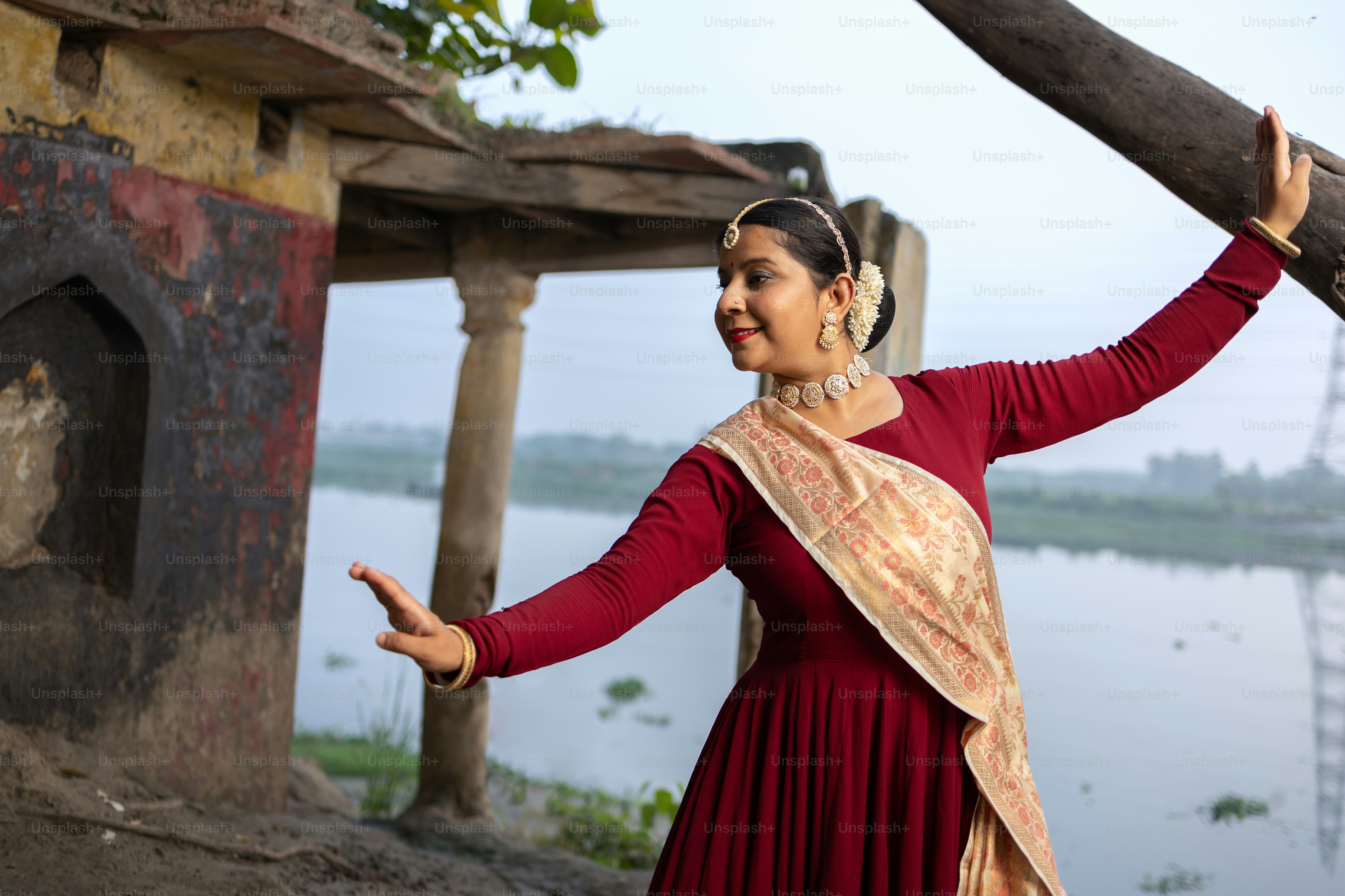 A woman in a red dress is holding a stick