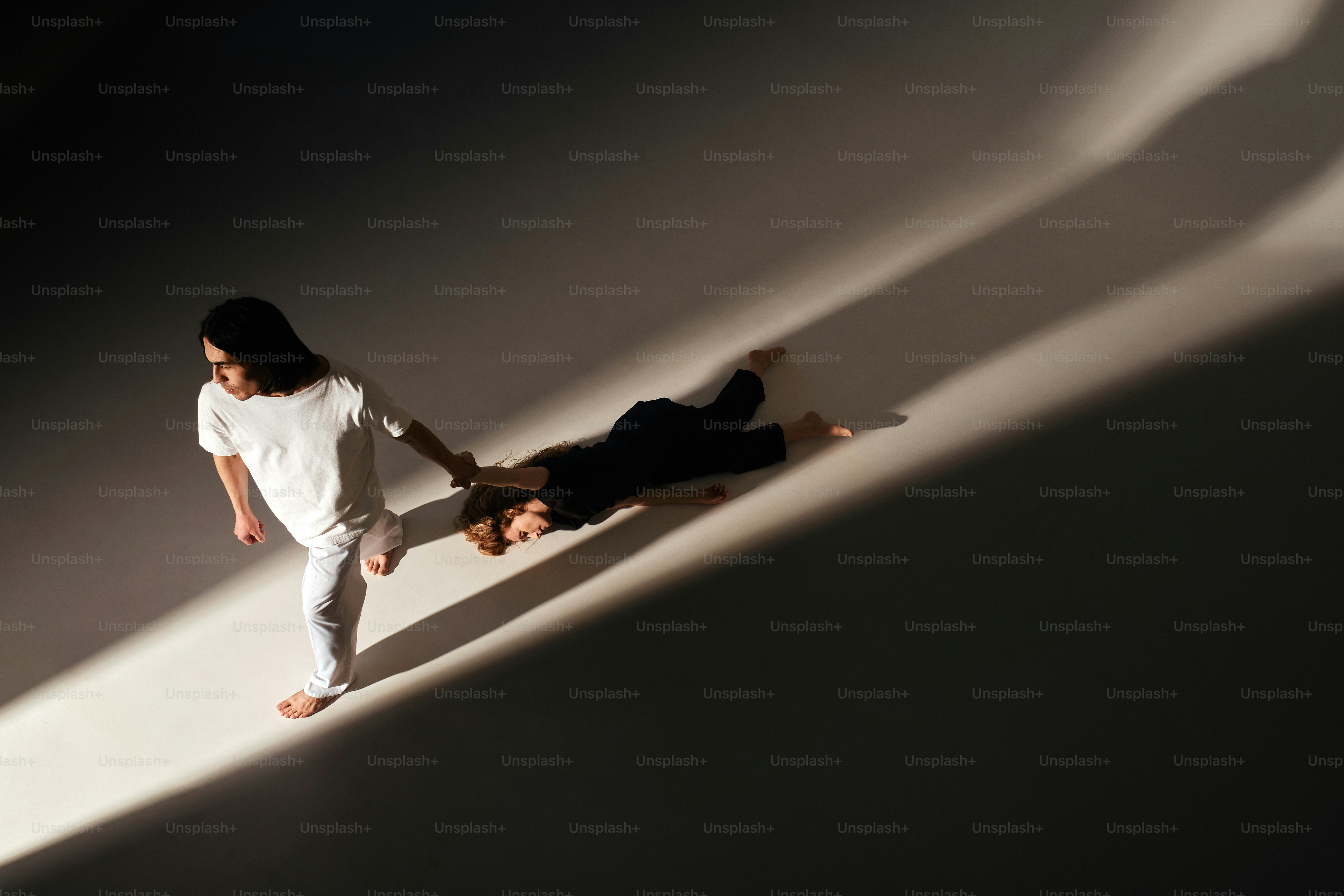 A couple of people that are standing in the shadows