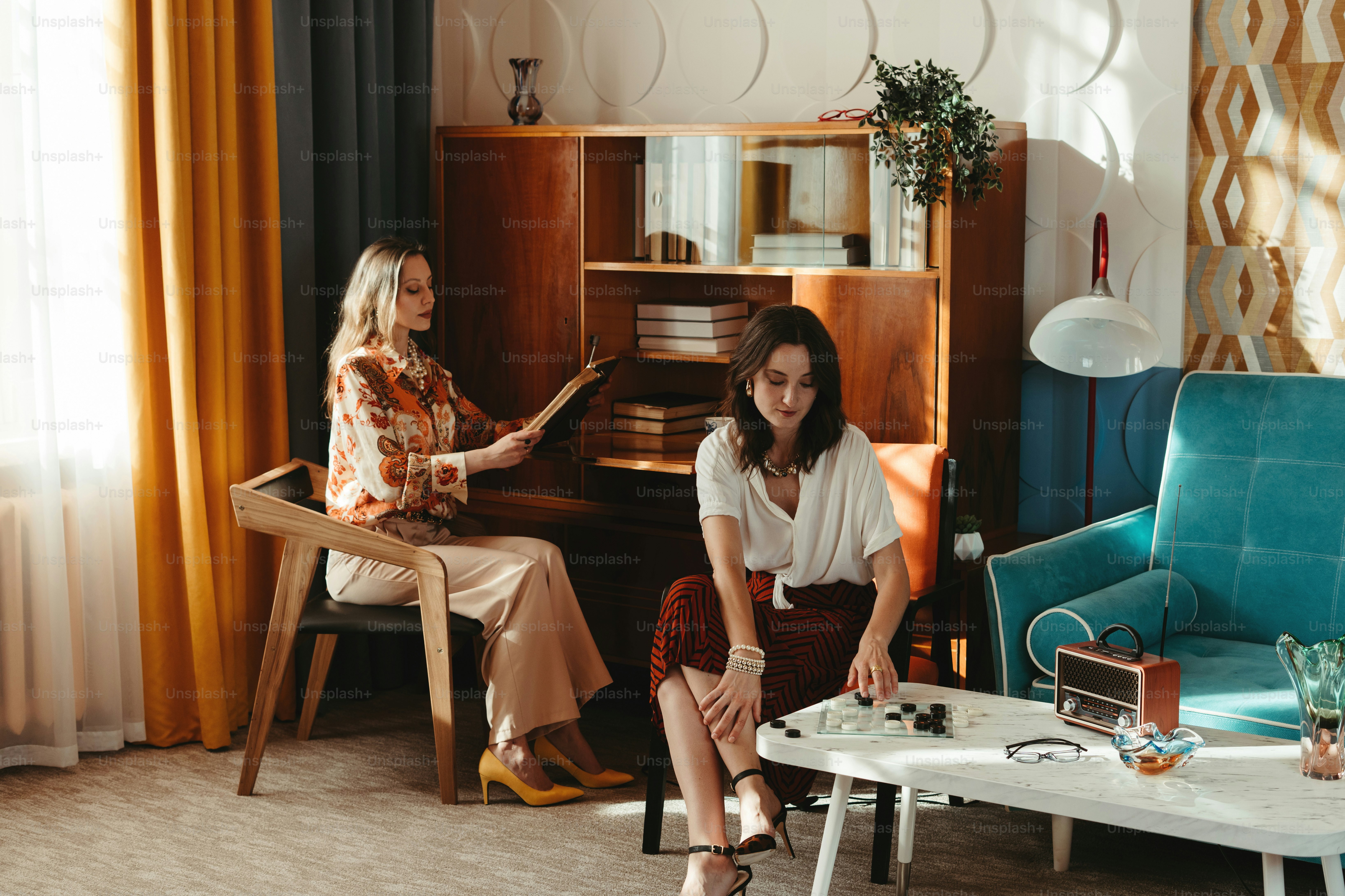 Two women sitting in a living room with a piano
