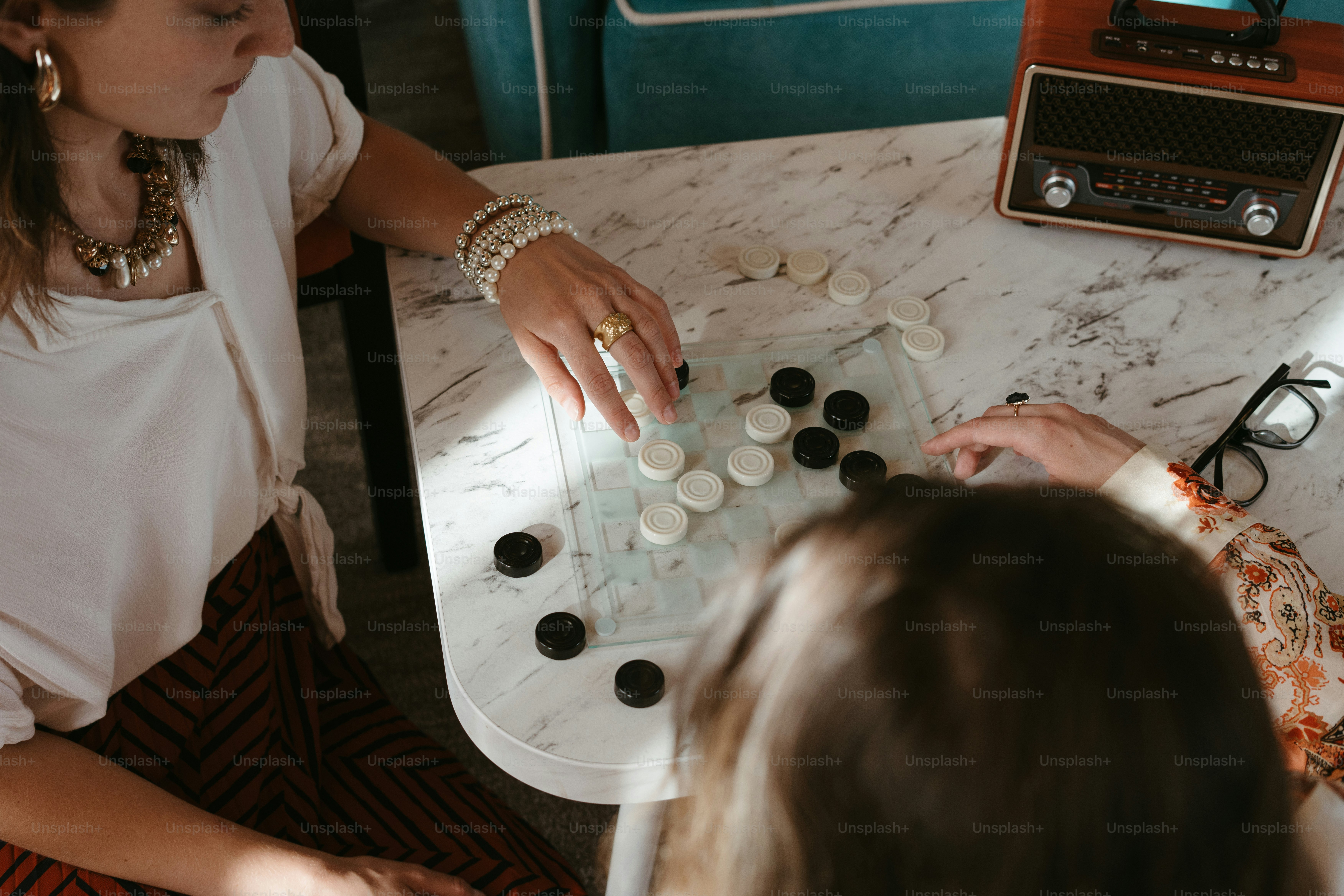 Two women sitting at a table playing a game
