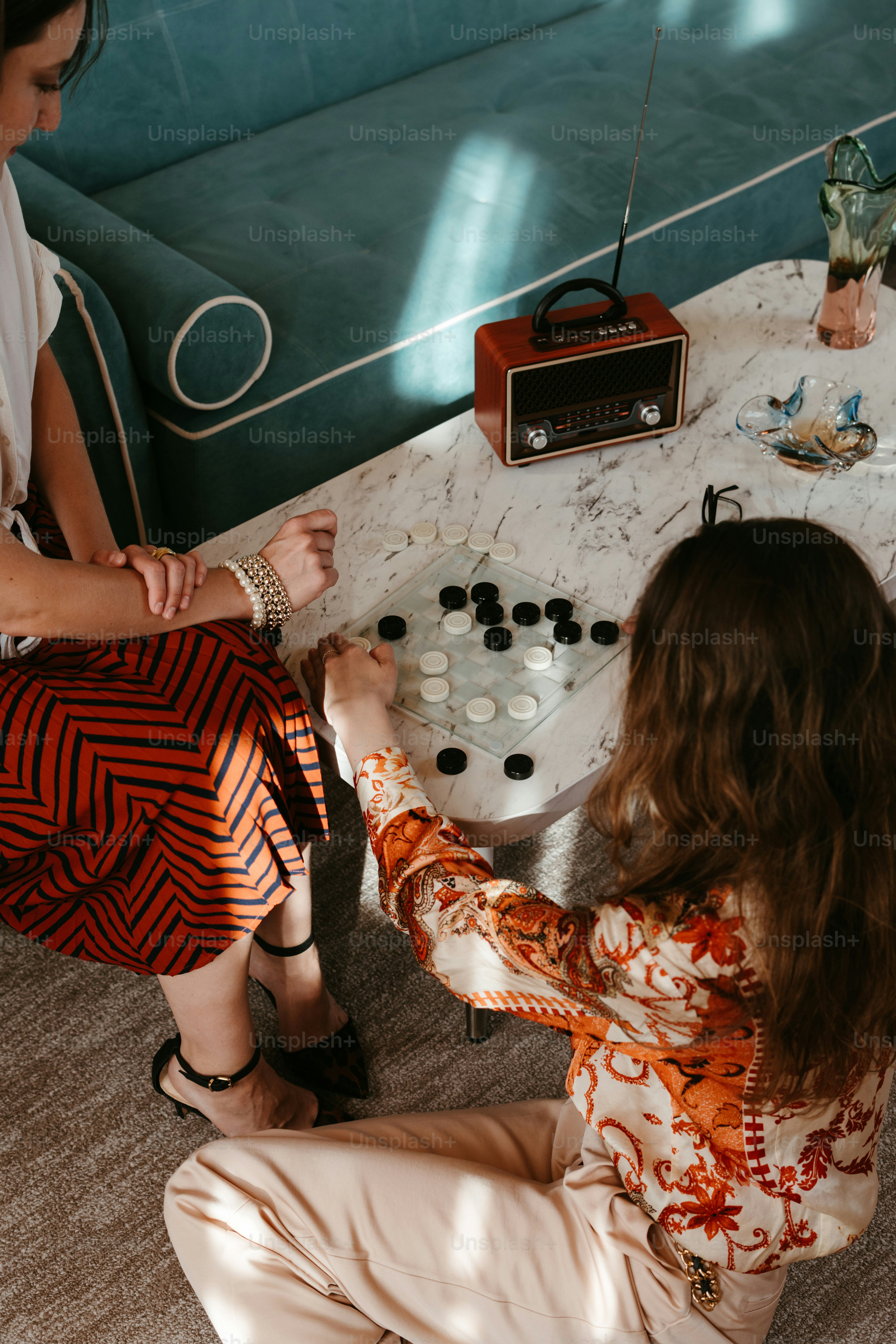 Two women playing a board game in a living room