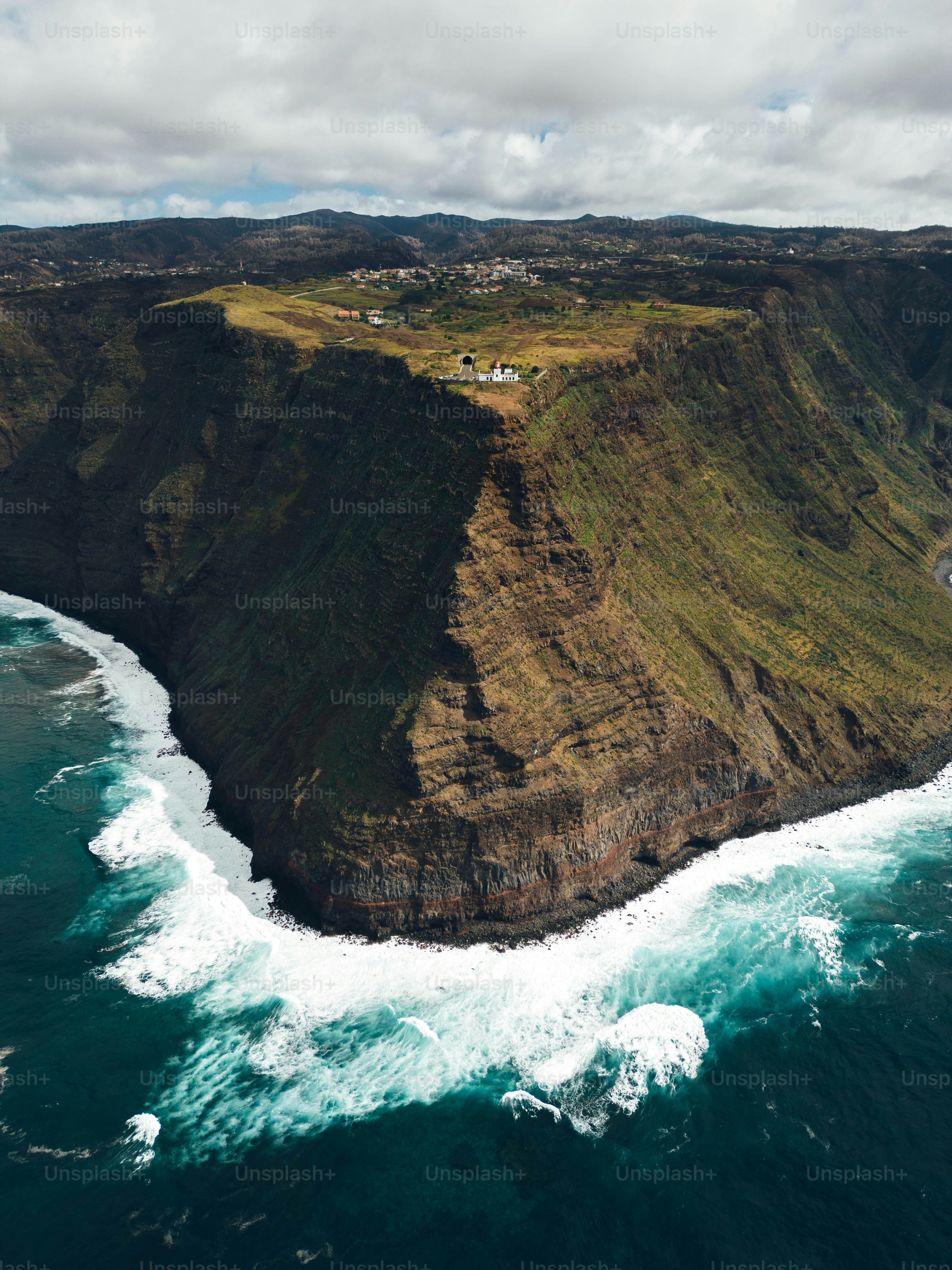An aerial view of the ocean and cliffs