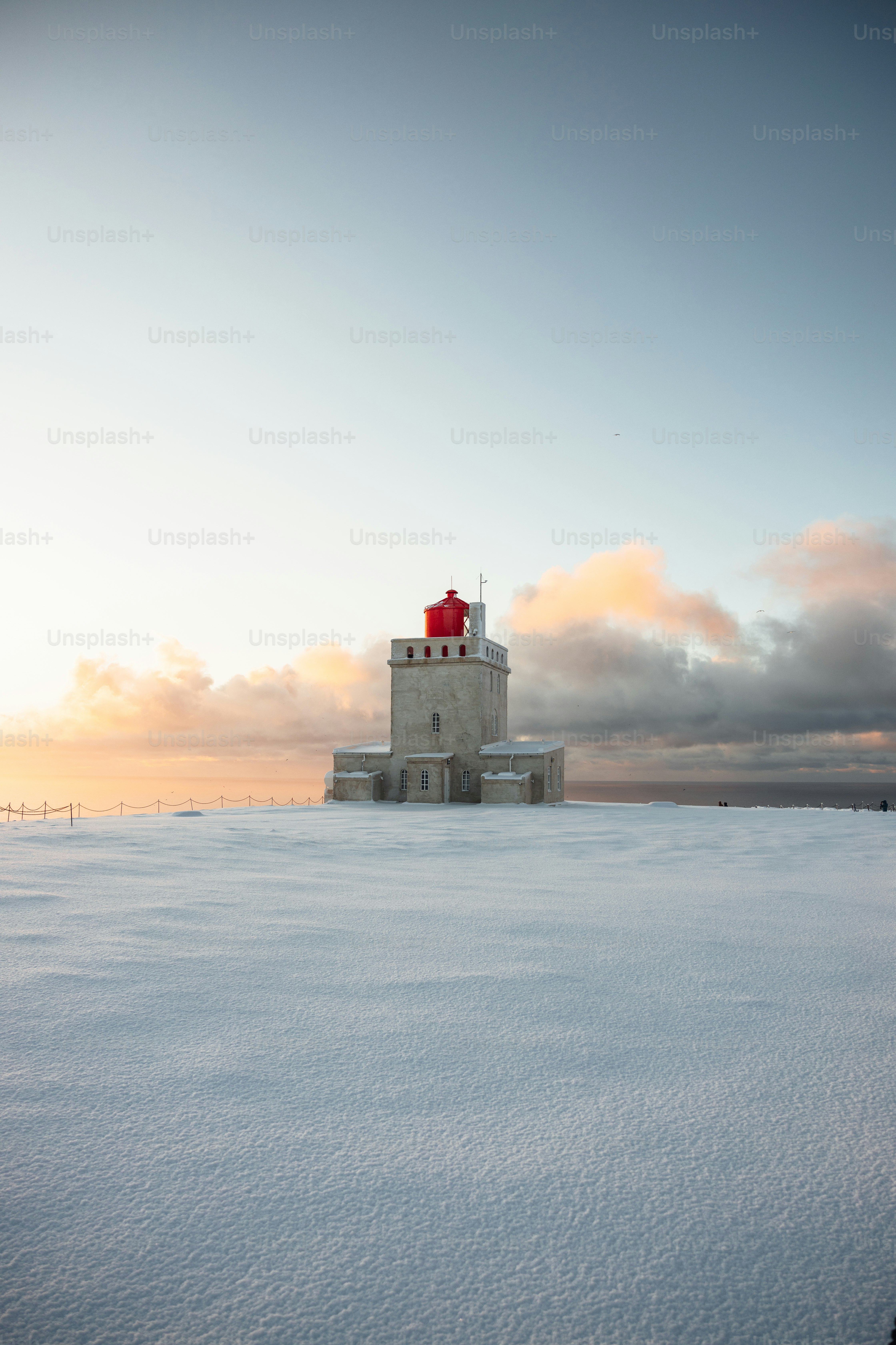 A lighthouse in the middle of a snowy field