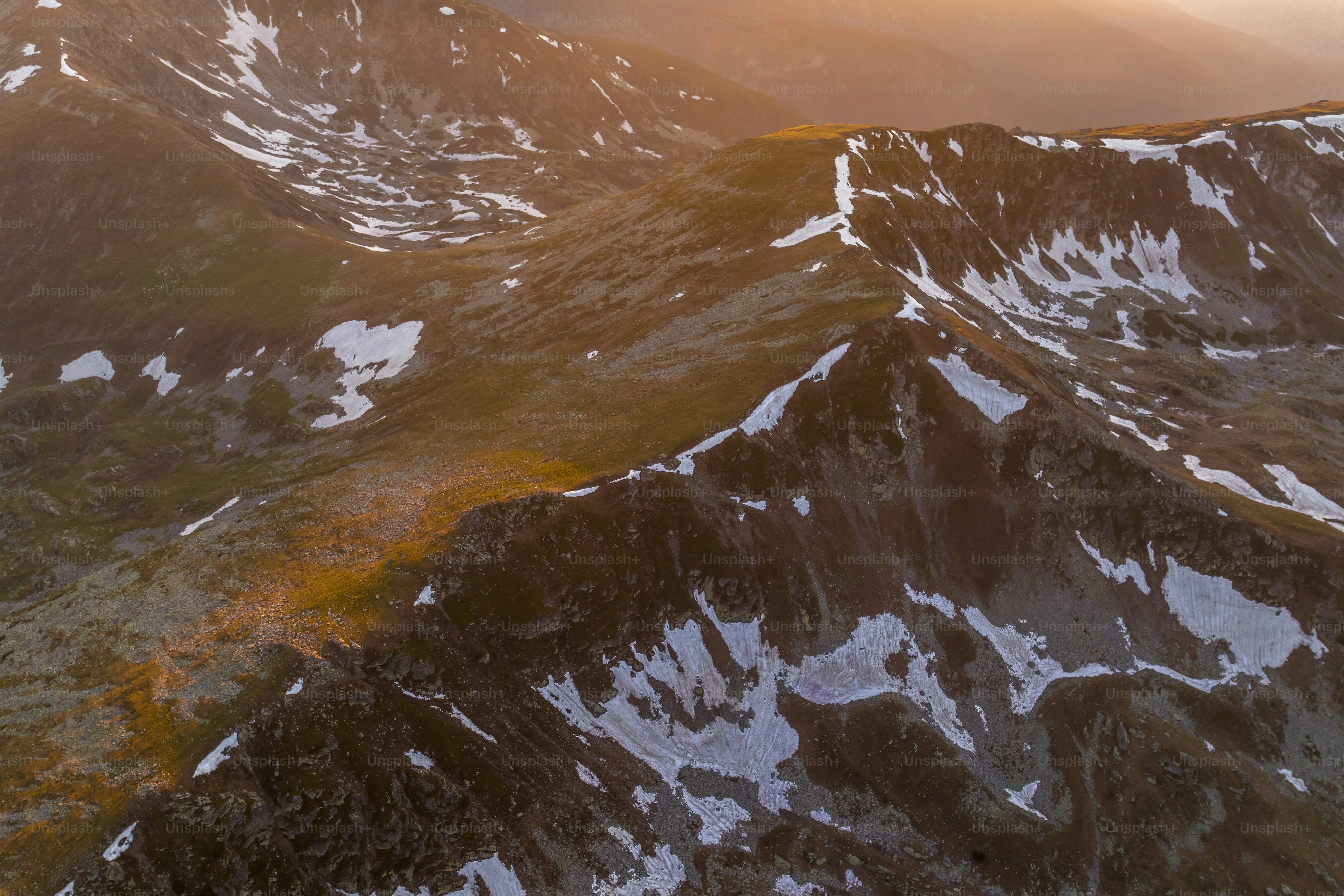 A view of the top of a mountain at sunset
