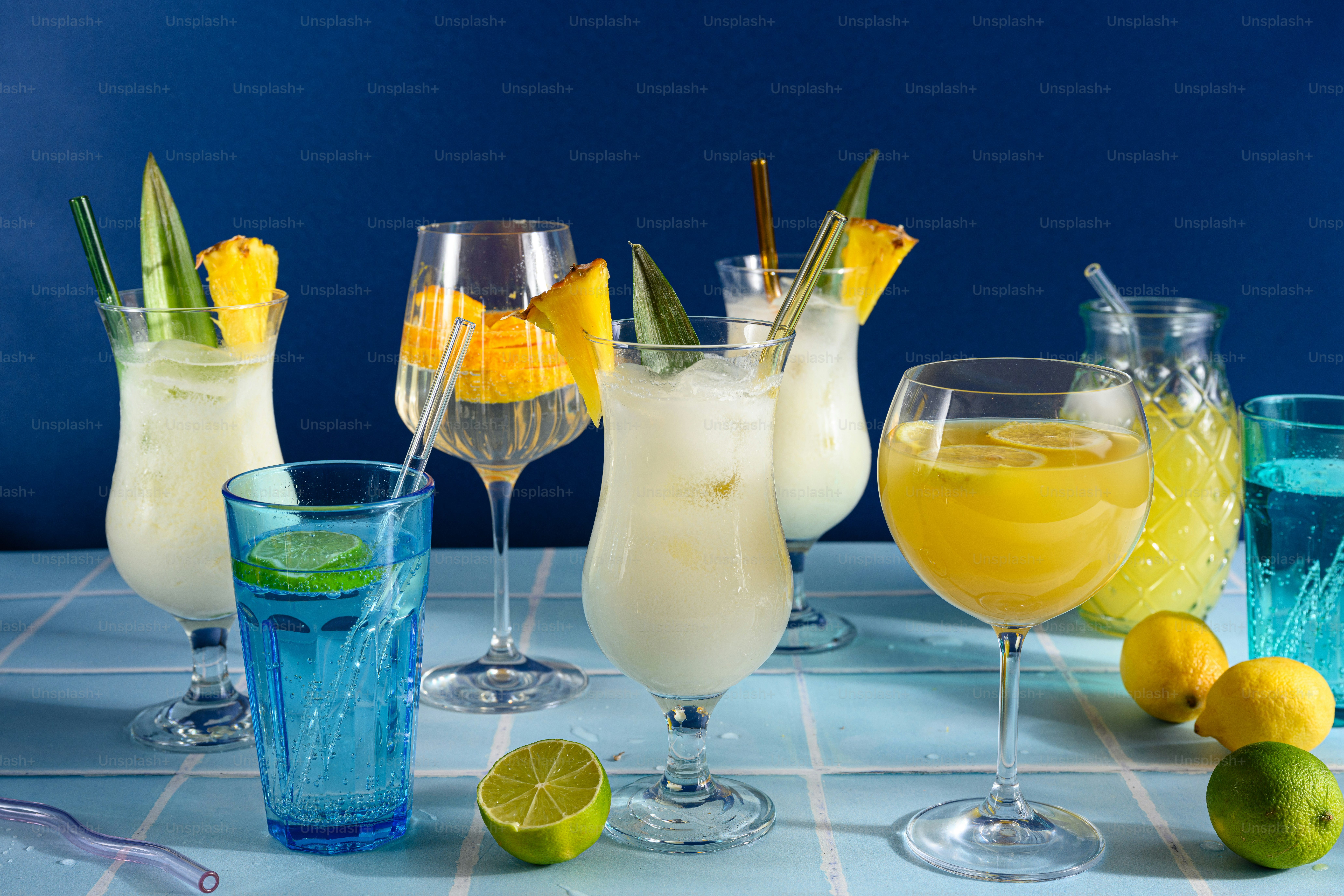 A table topped with glasses filled with different types of drinks