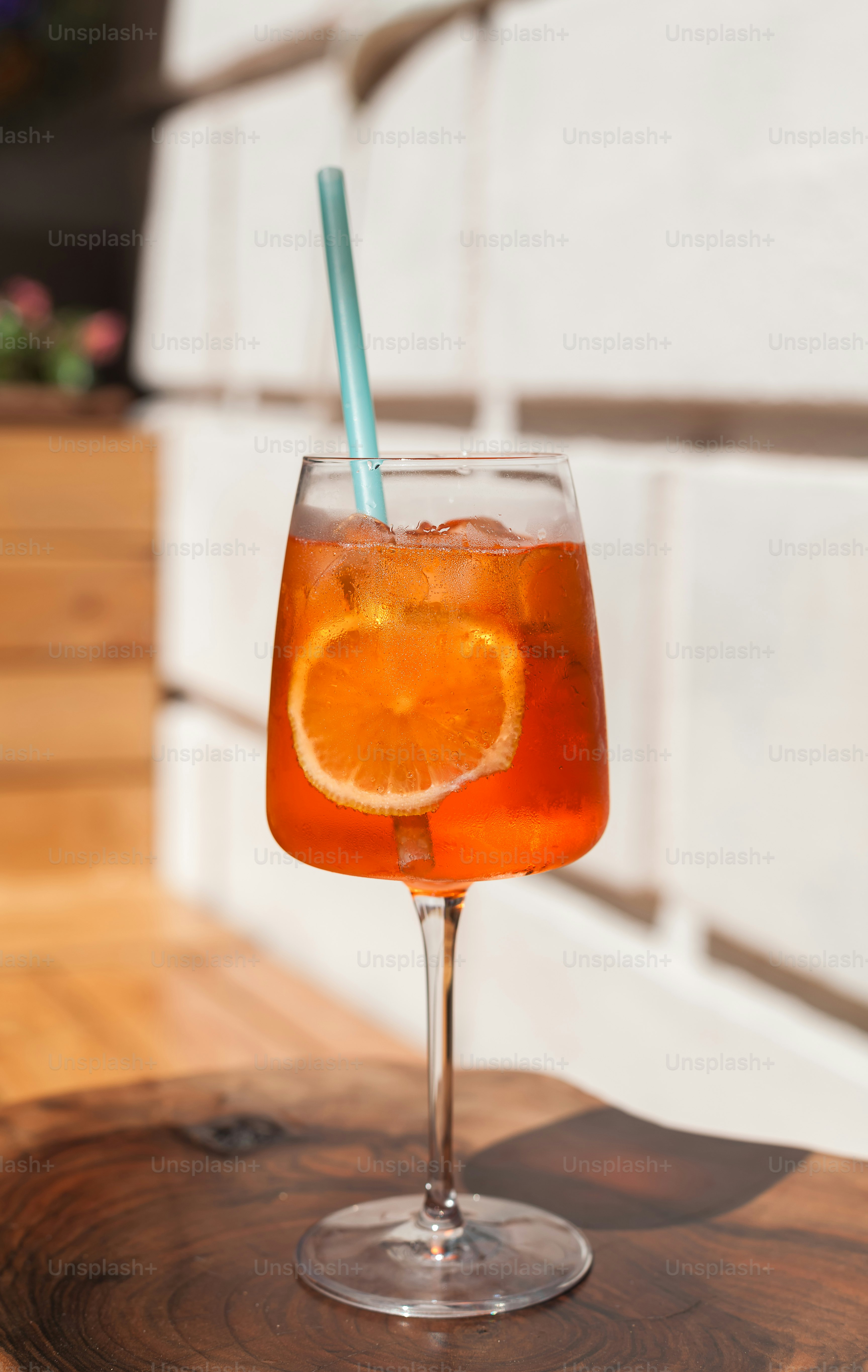 A glass of orange juice on a wooden table