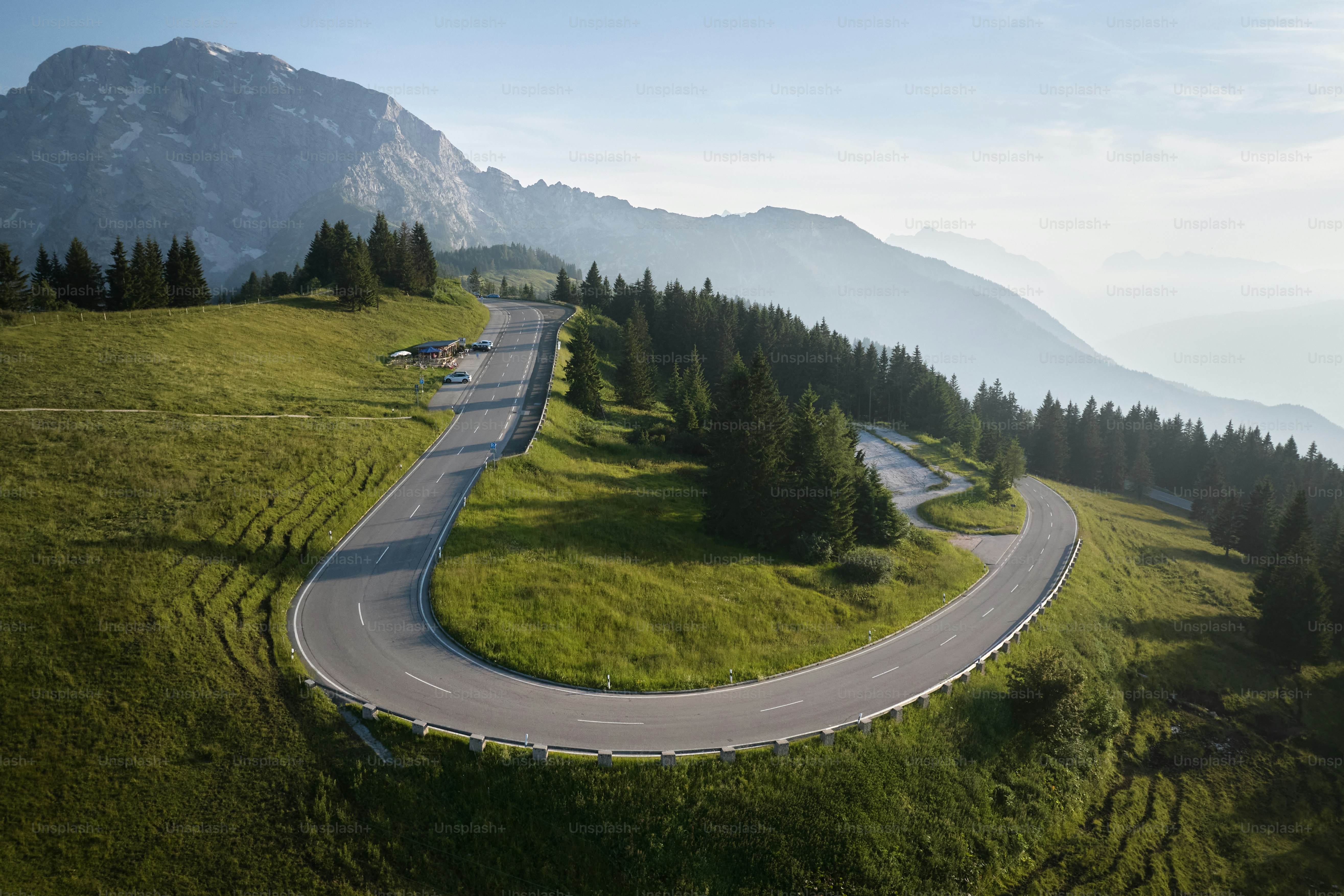 An aerial view of a winding road in the mountains
