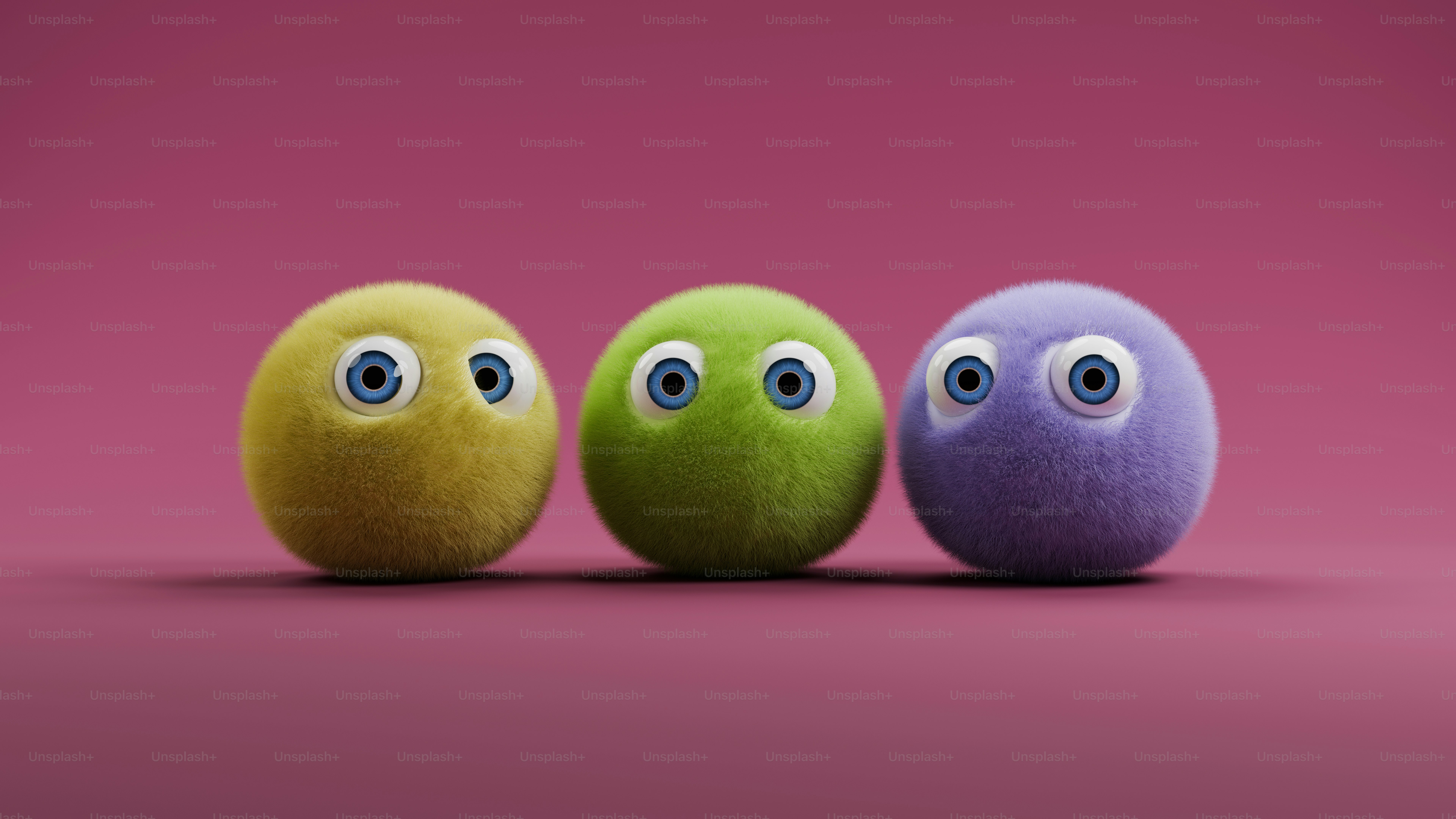 Three different colored eggs with eyes on a pink background