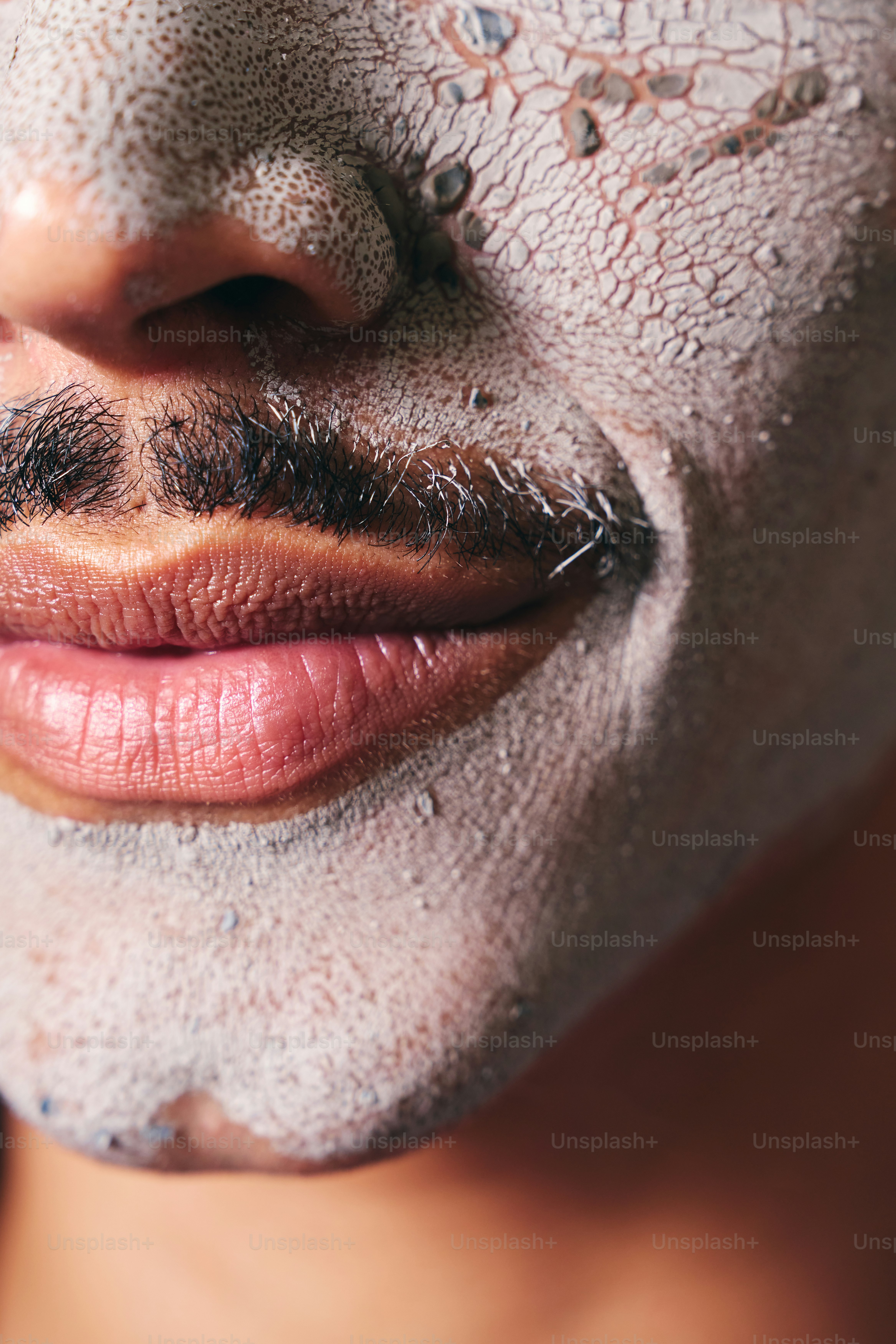 A woman with a facial mask on and a moustache on her face