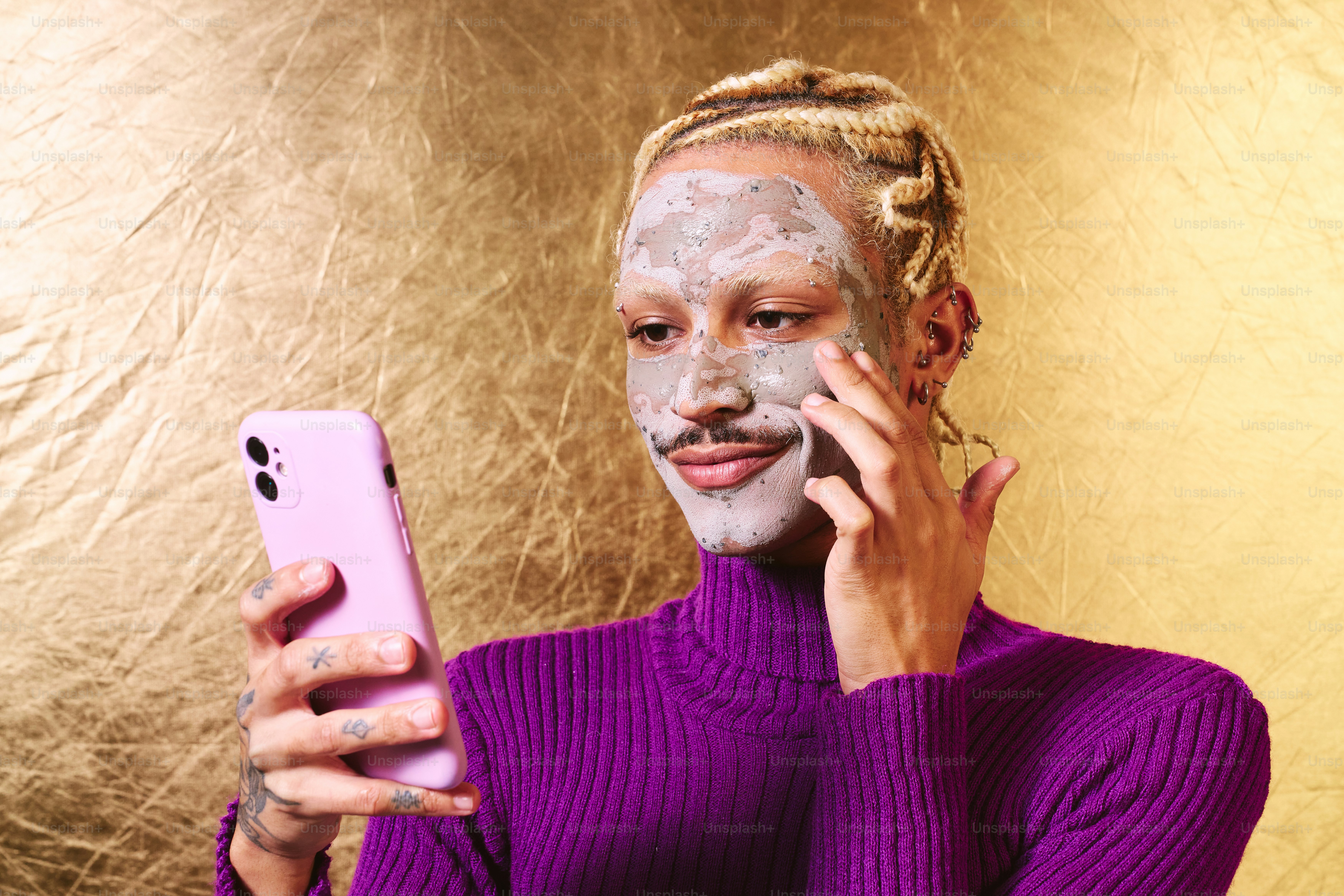 A woman in a purple sweater using a cell phone
