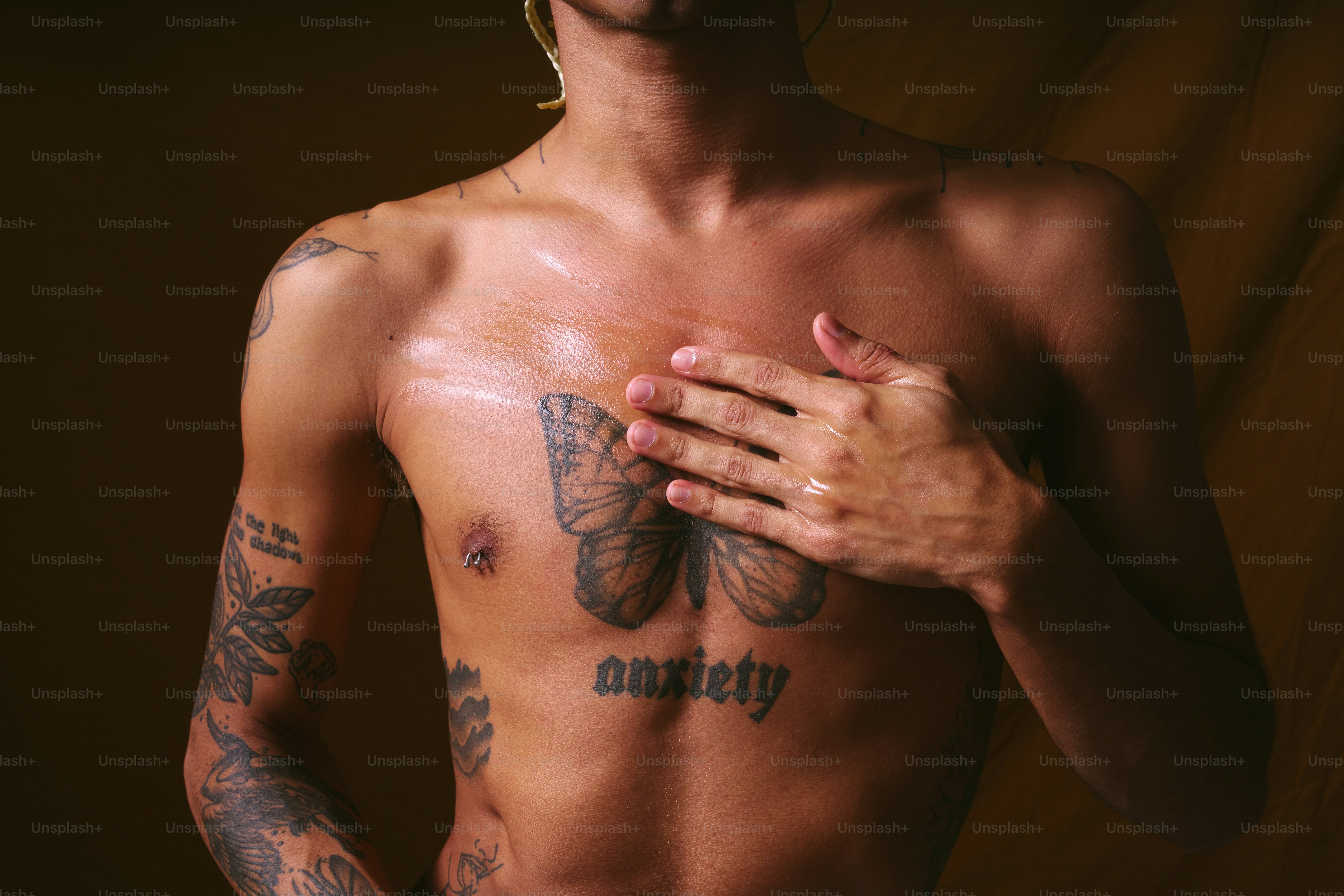 A shirtless man with tattoos holding his hands together photo – Skincare  Image on Unsplash, image size:3000x2000