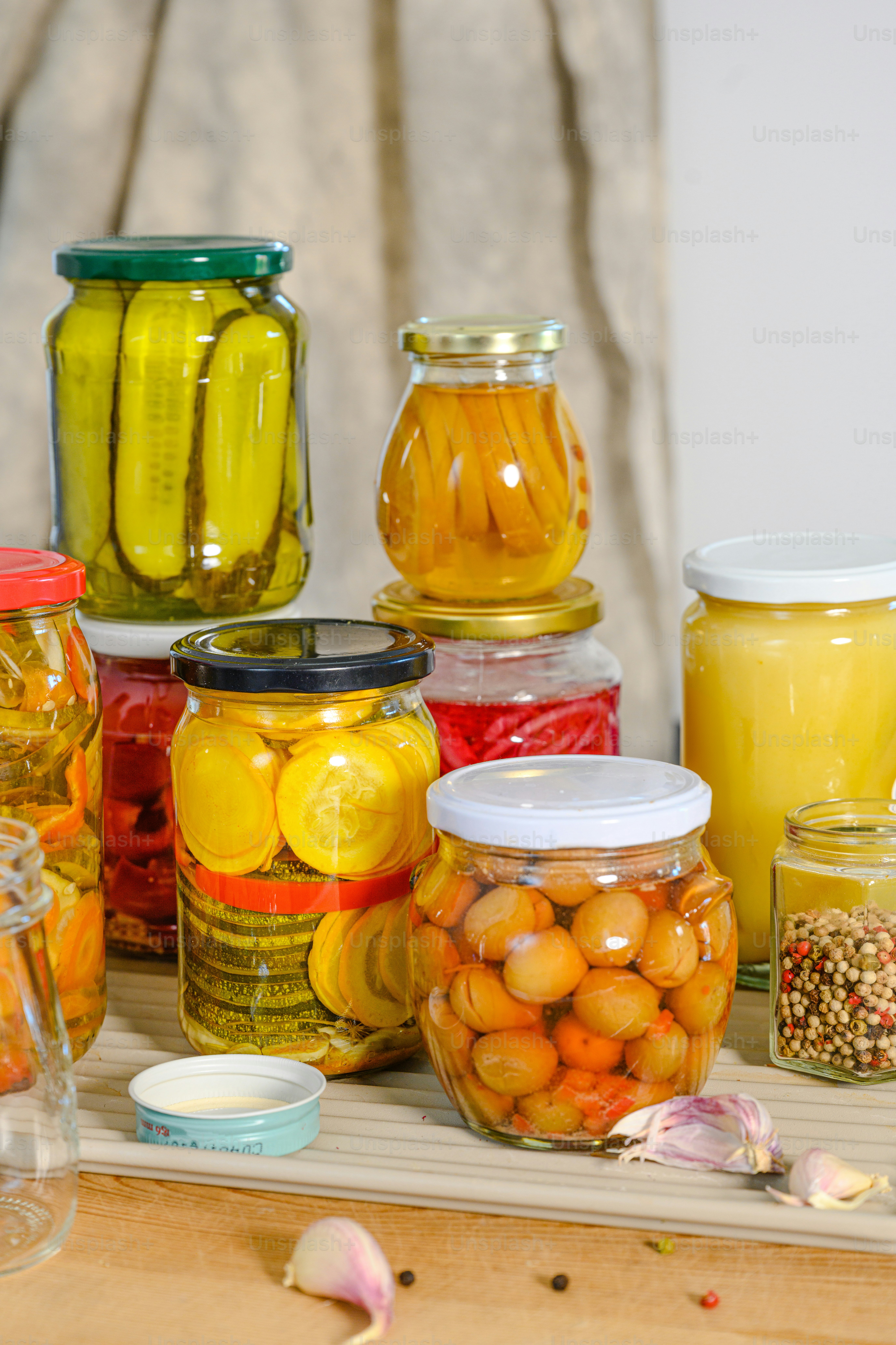 A table topped with lots of jars filled with food