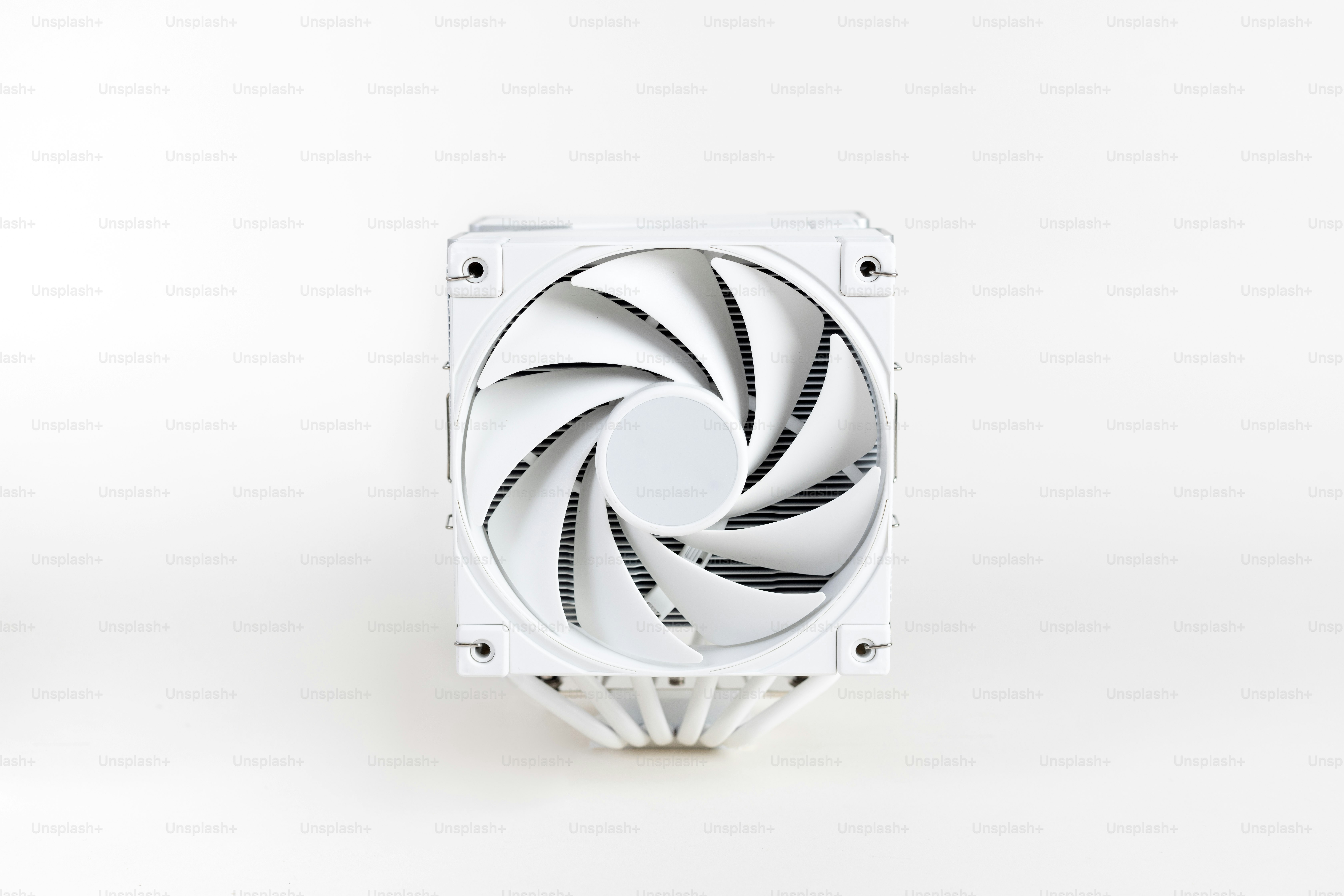 A white fan sitting on top of a white table