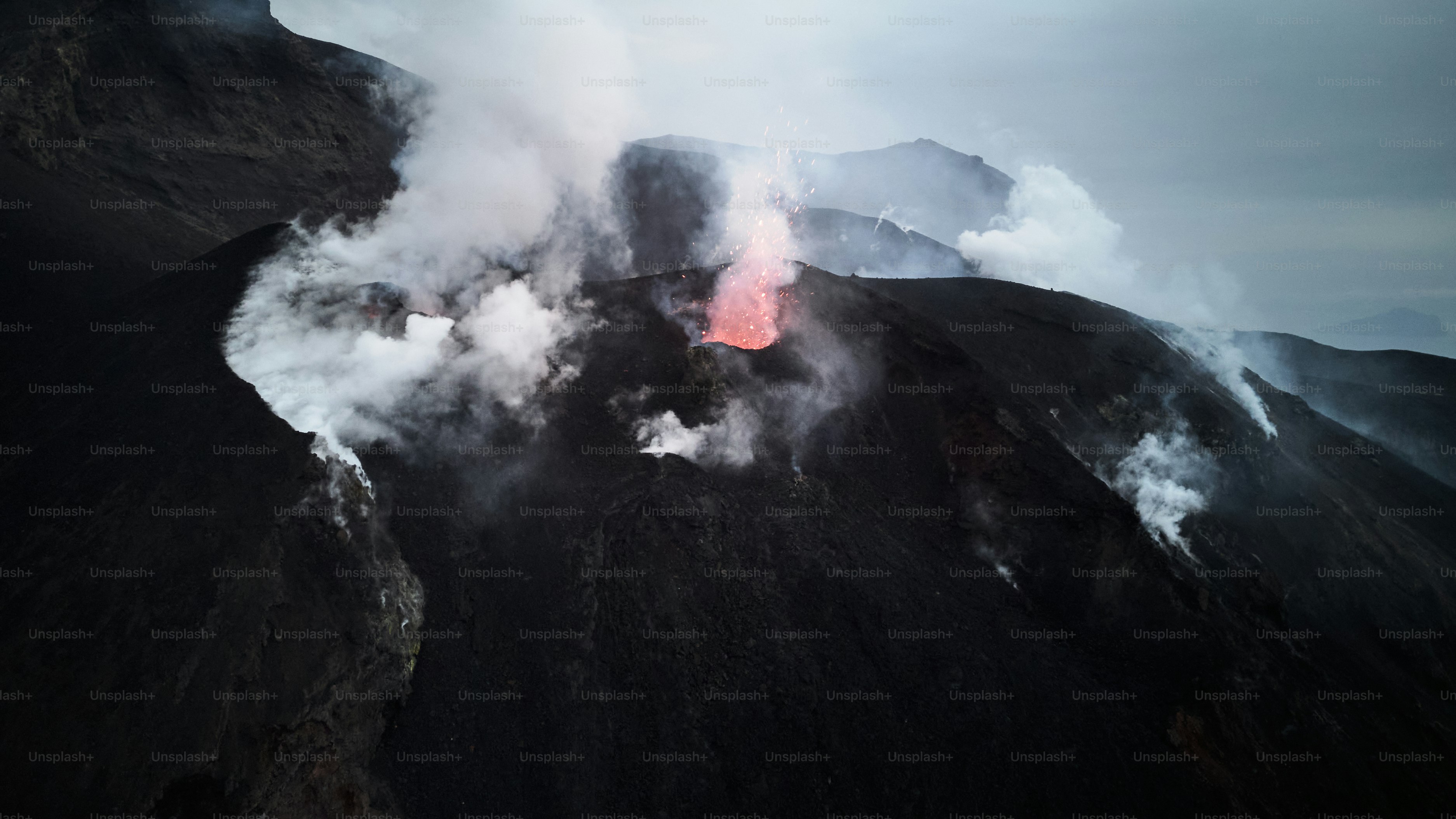 A mountain with a red light in the middle of it