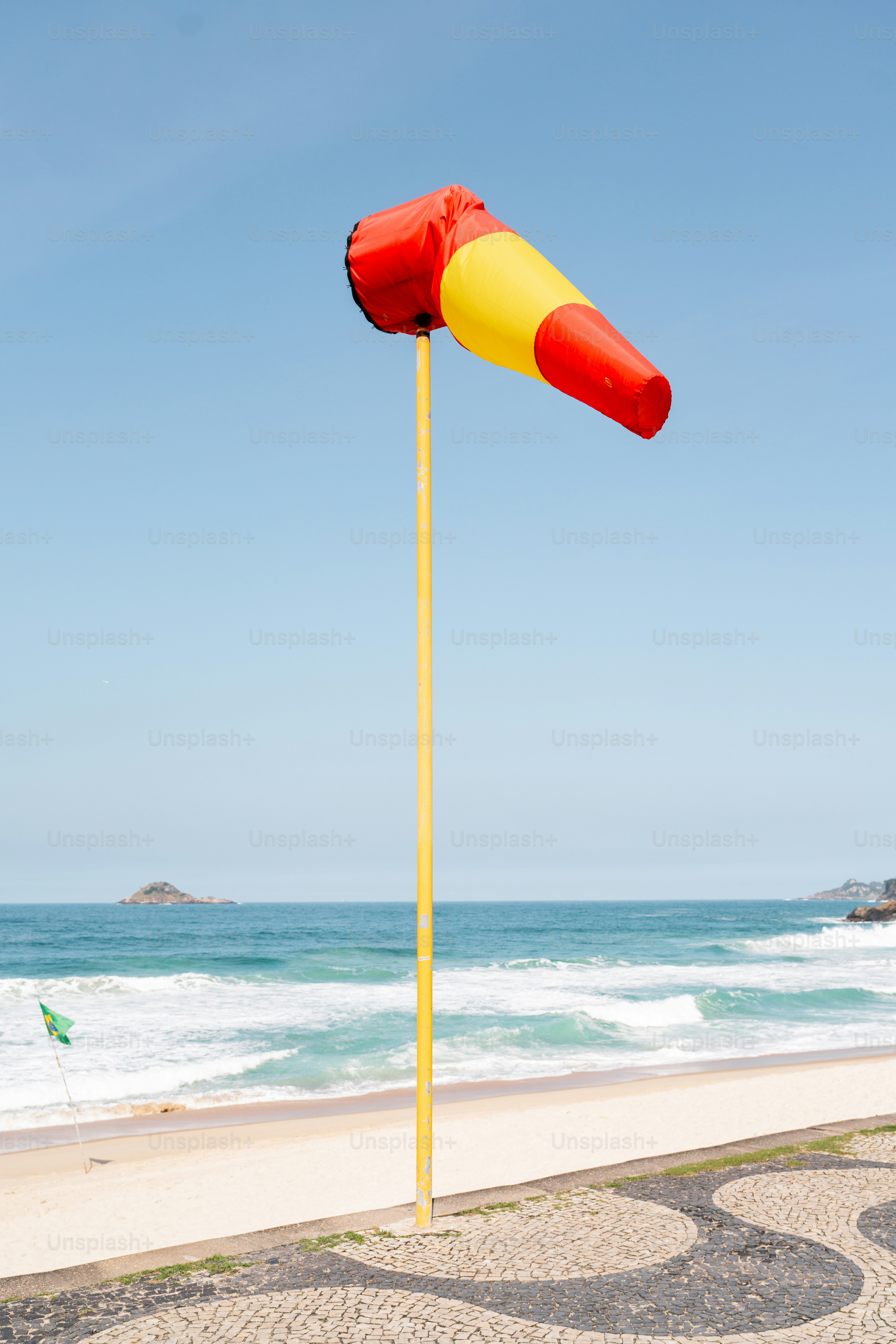 A lifeguard pole on a beach next to the ocean