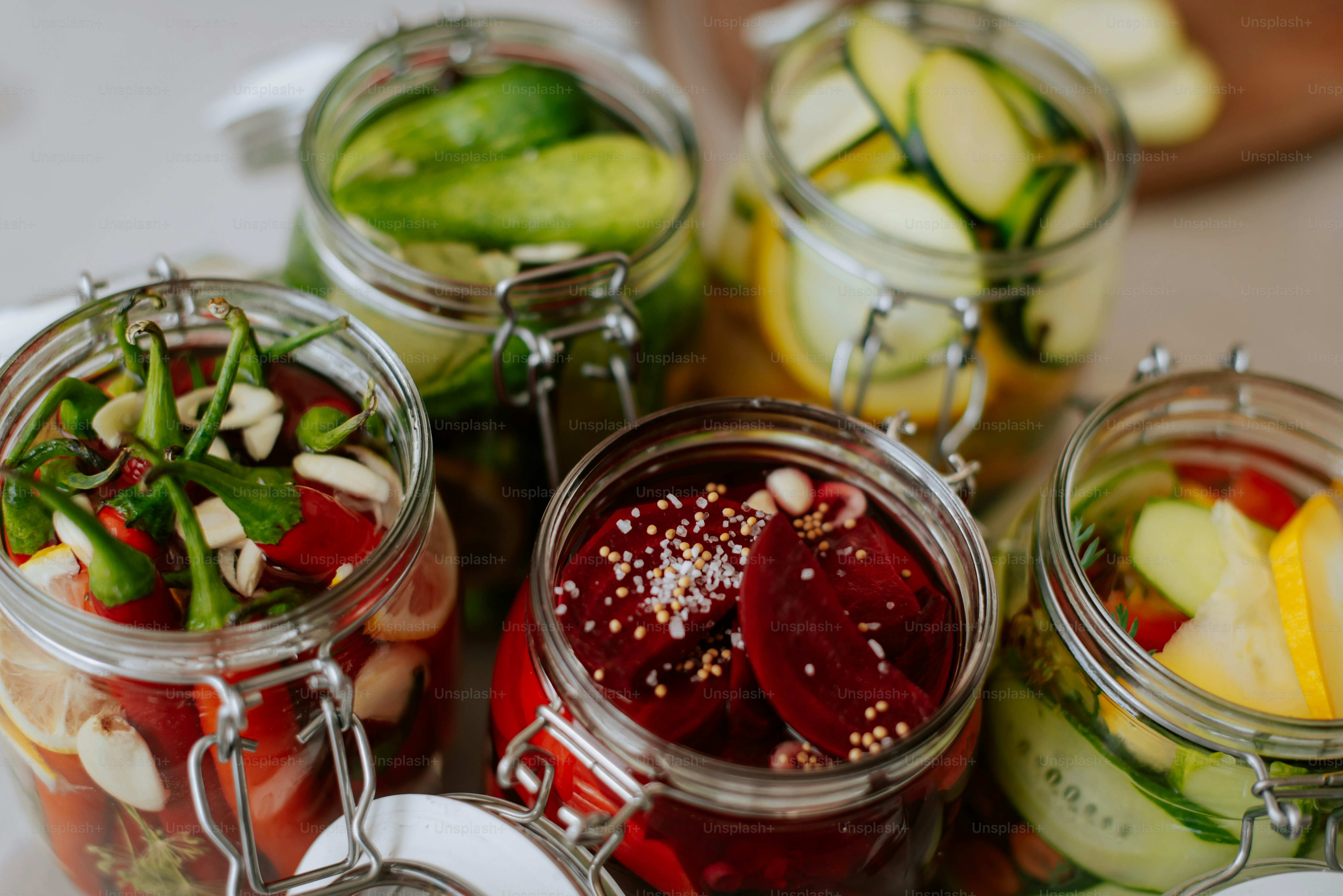 A bunch of jars filled with different types of food