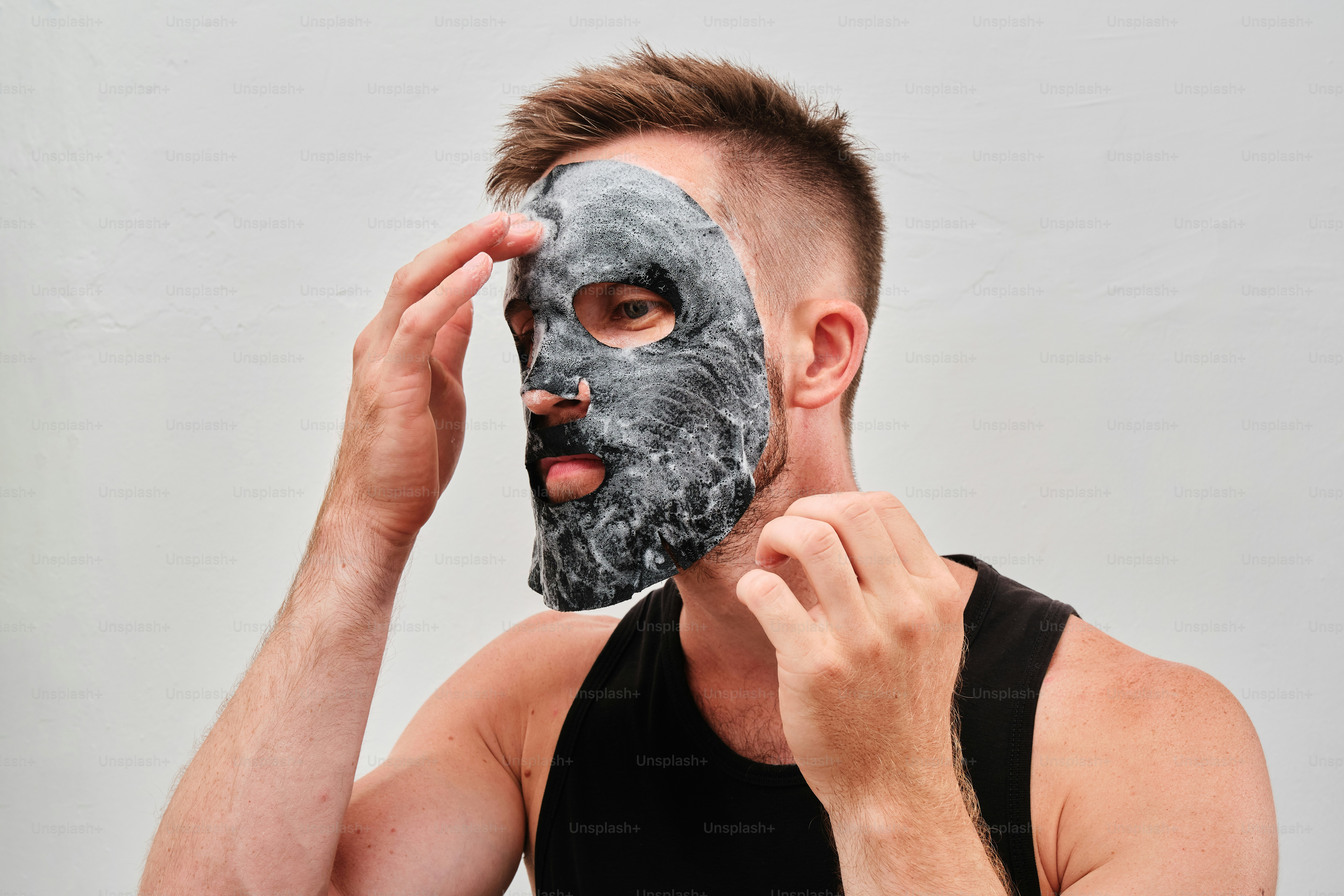 A man applying face mask