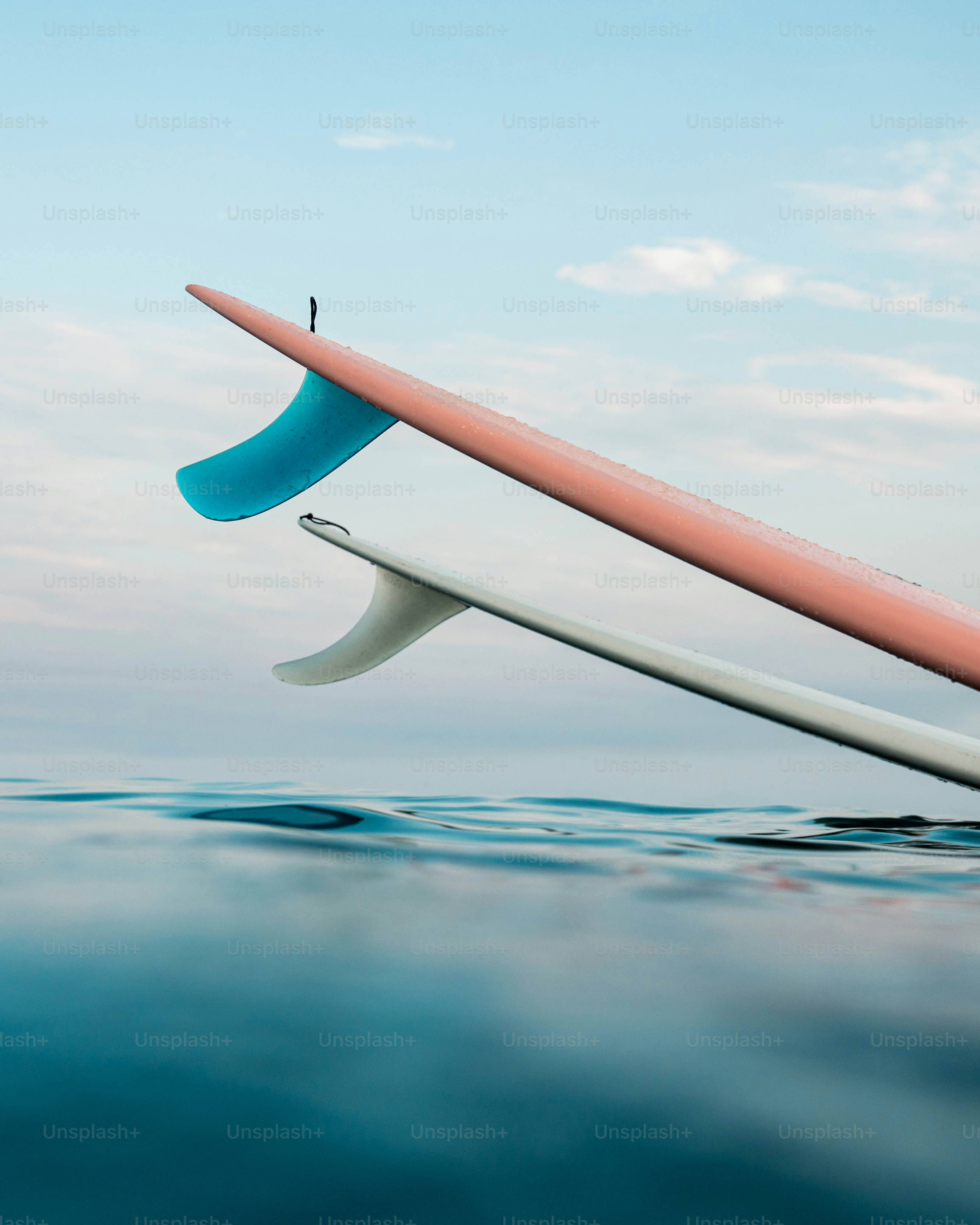 Two surfboards sticking out of the water