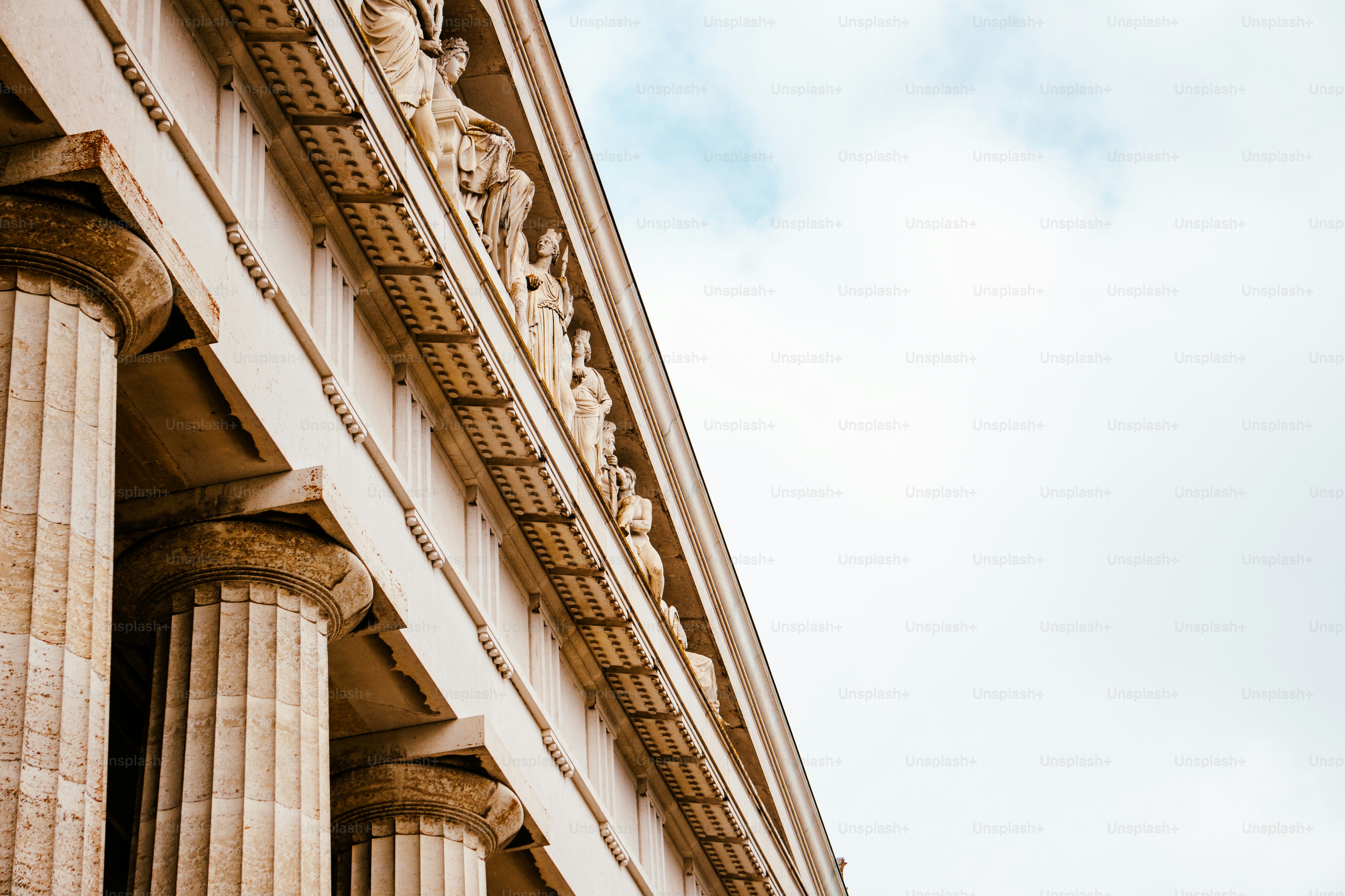 A building with columns and a clock on the side of it