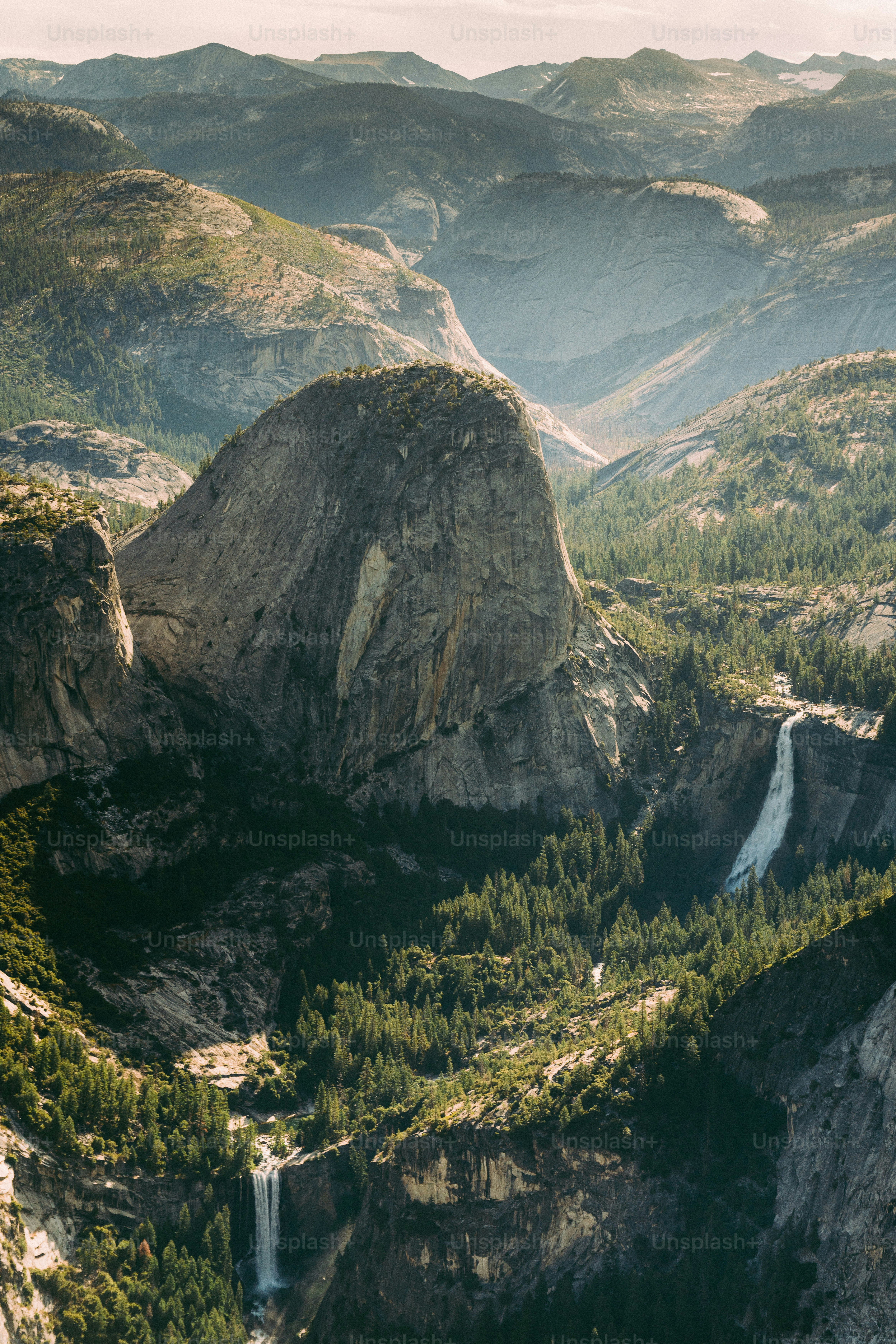 A scenic view of a valley with a waterfall