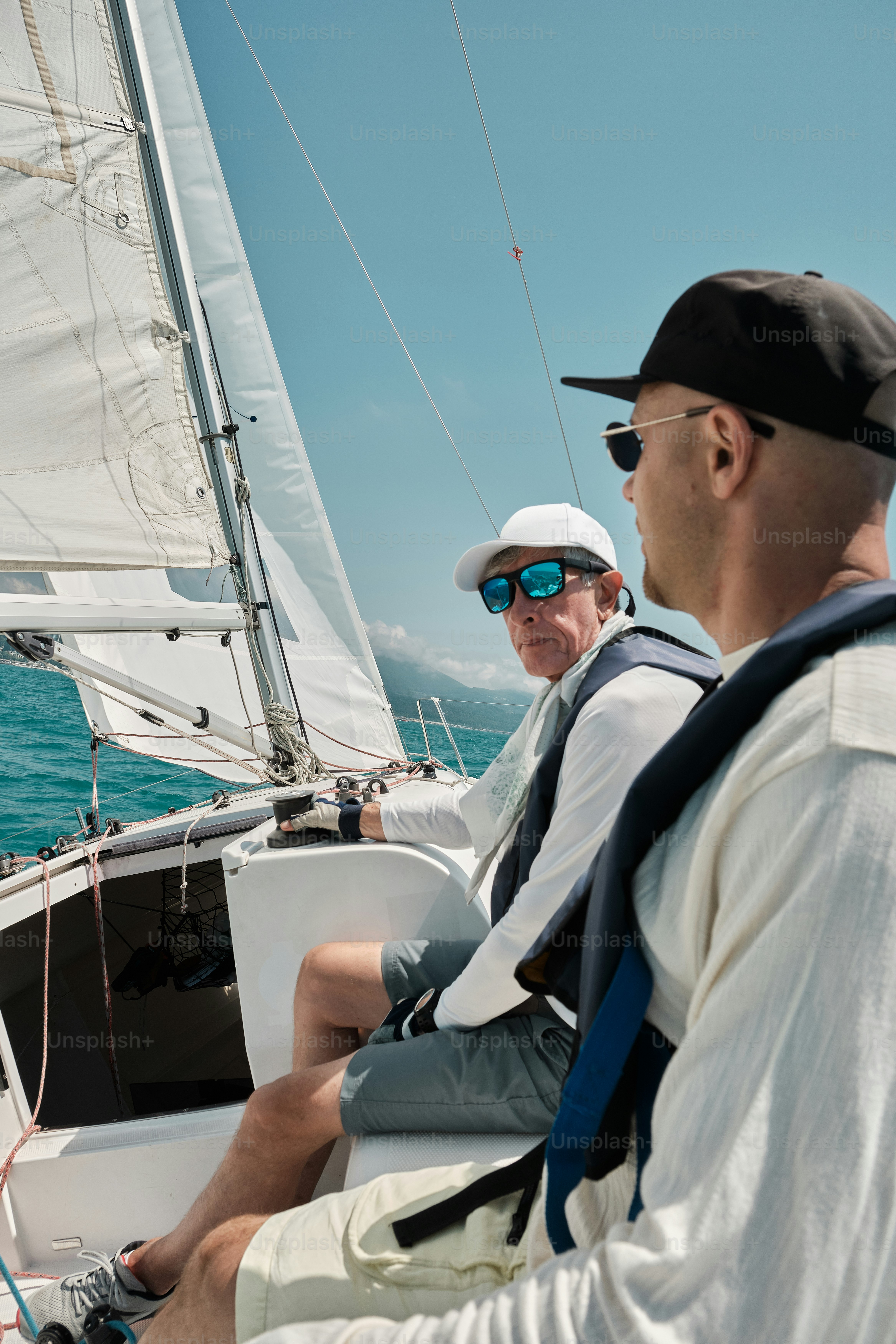 A couple of men riding on the back of a boat