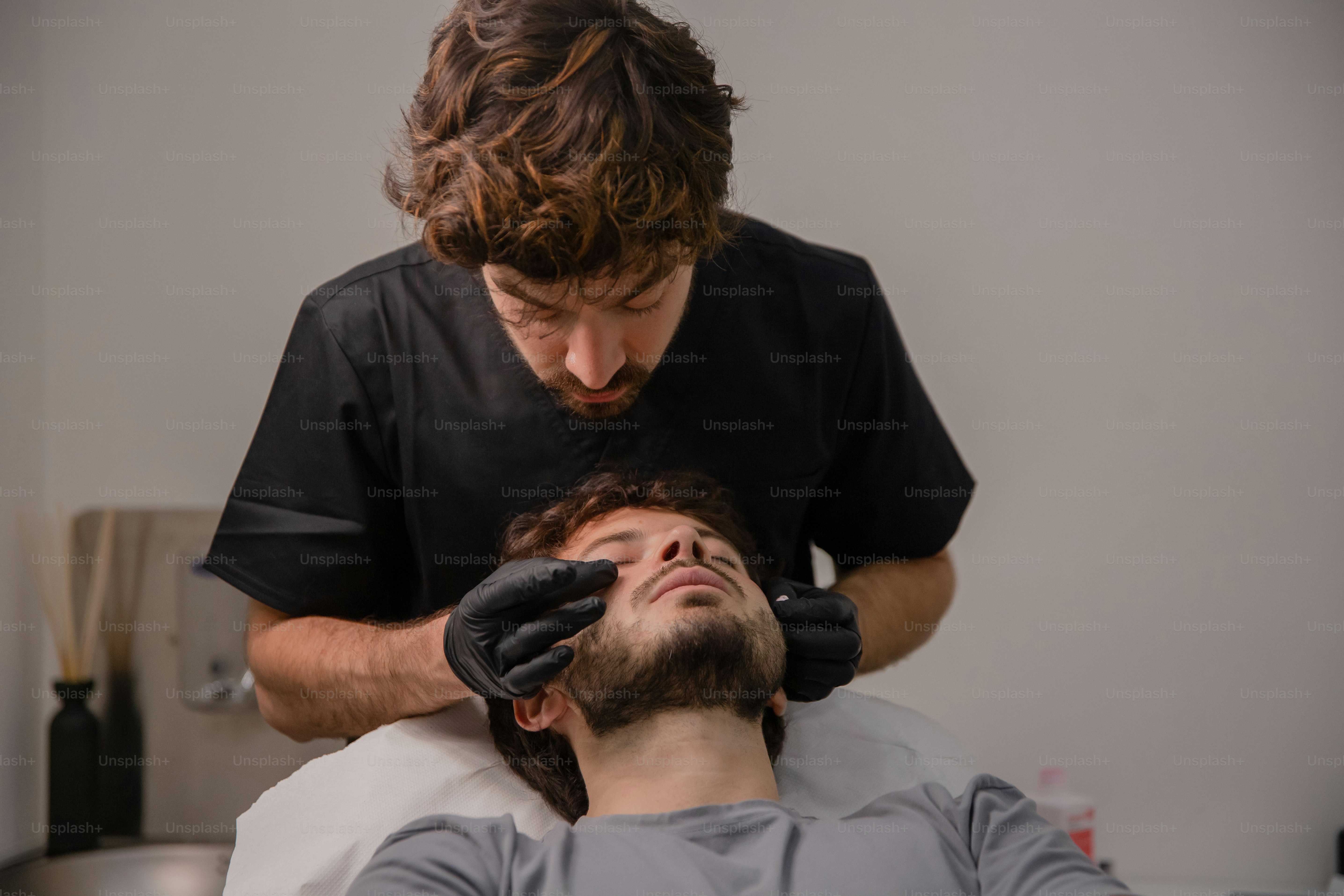 A man getting his hair cut by a barber