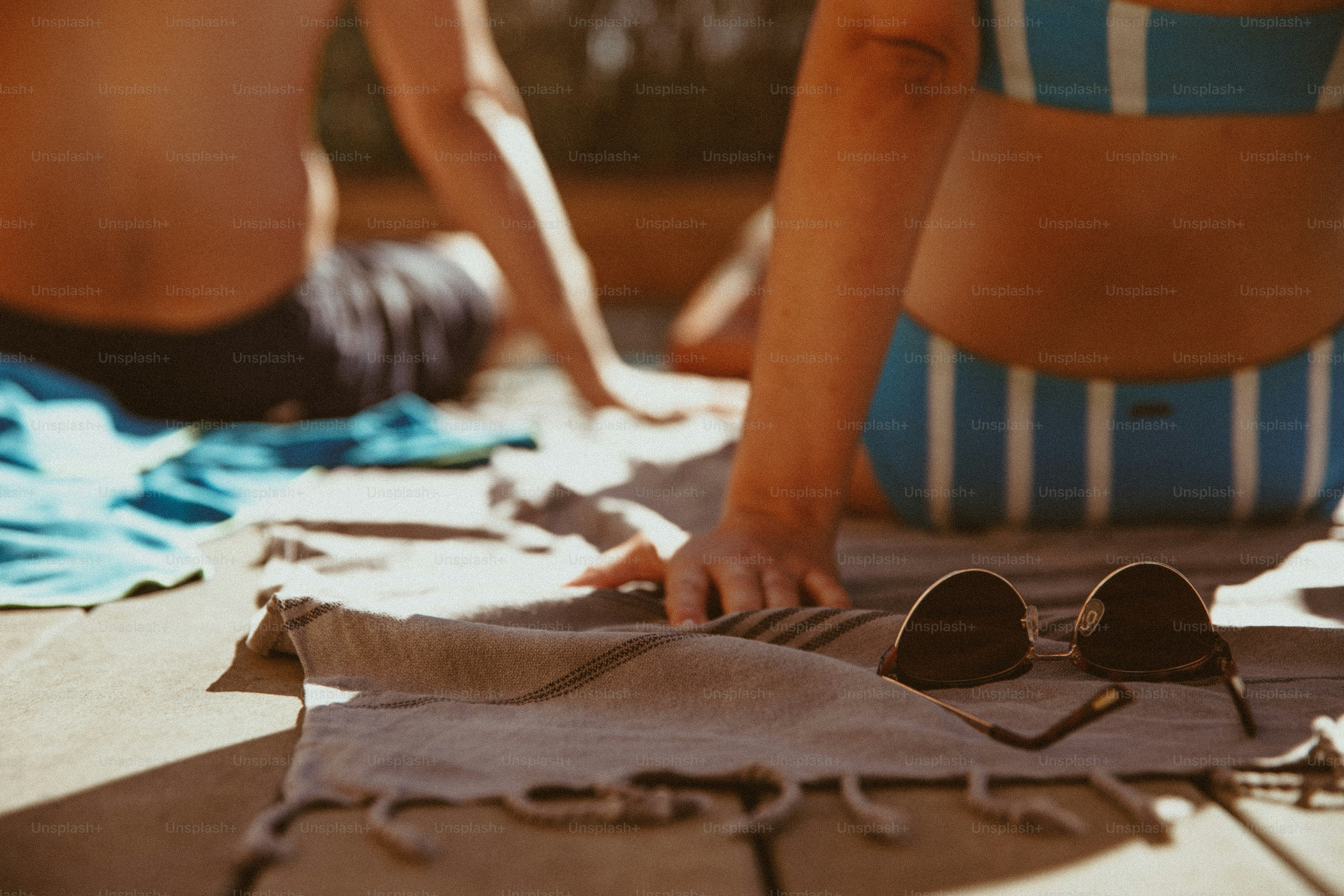 A woman in a blue and white bathing suit laying on the ground