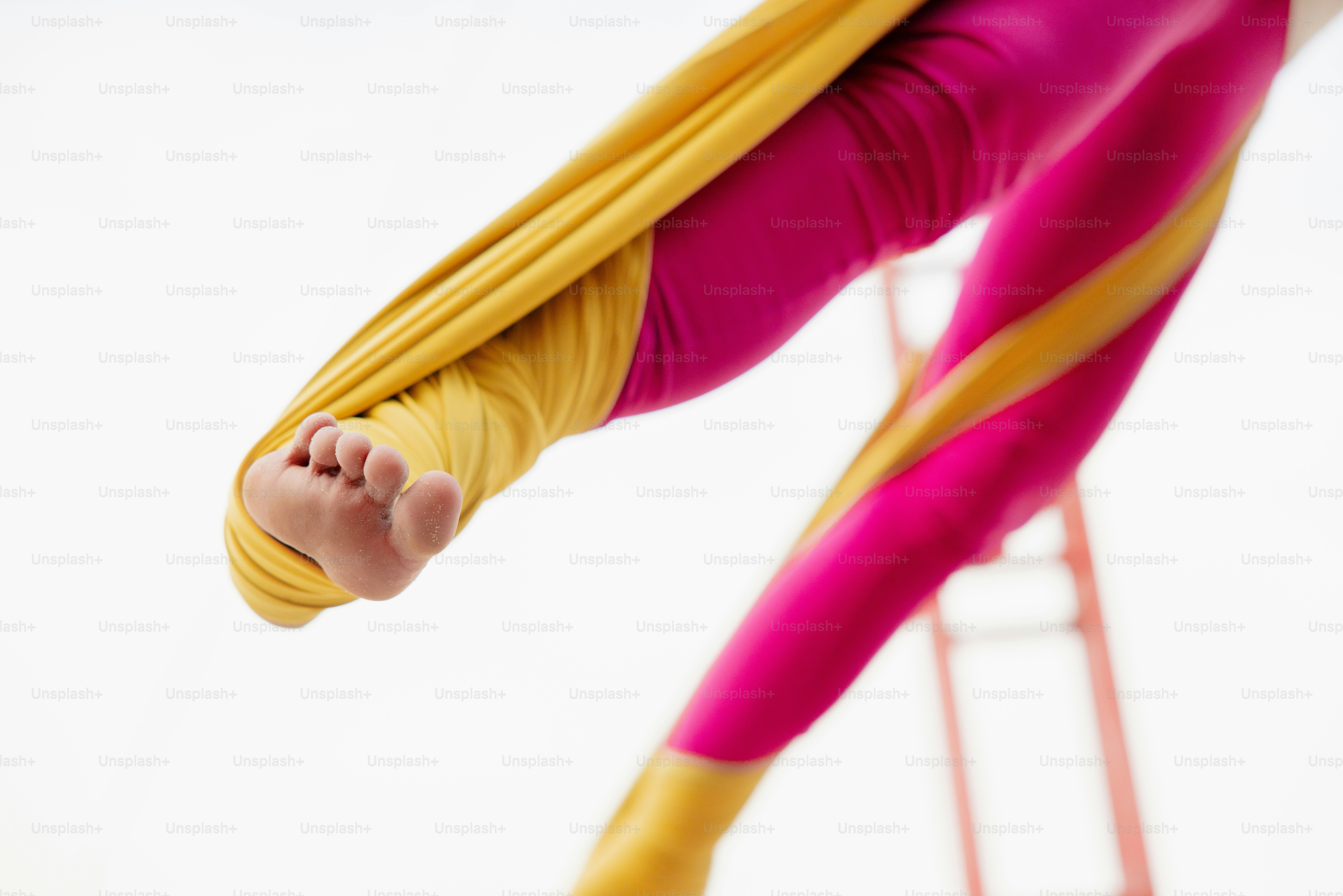 A woman is doing a handstand on a pole