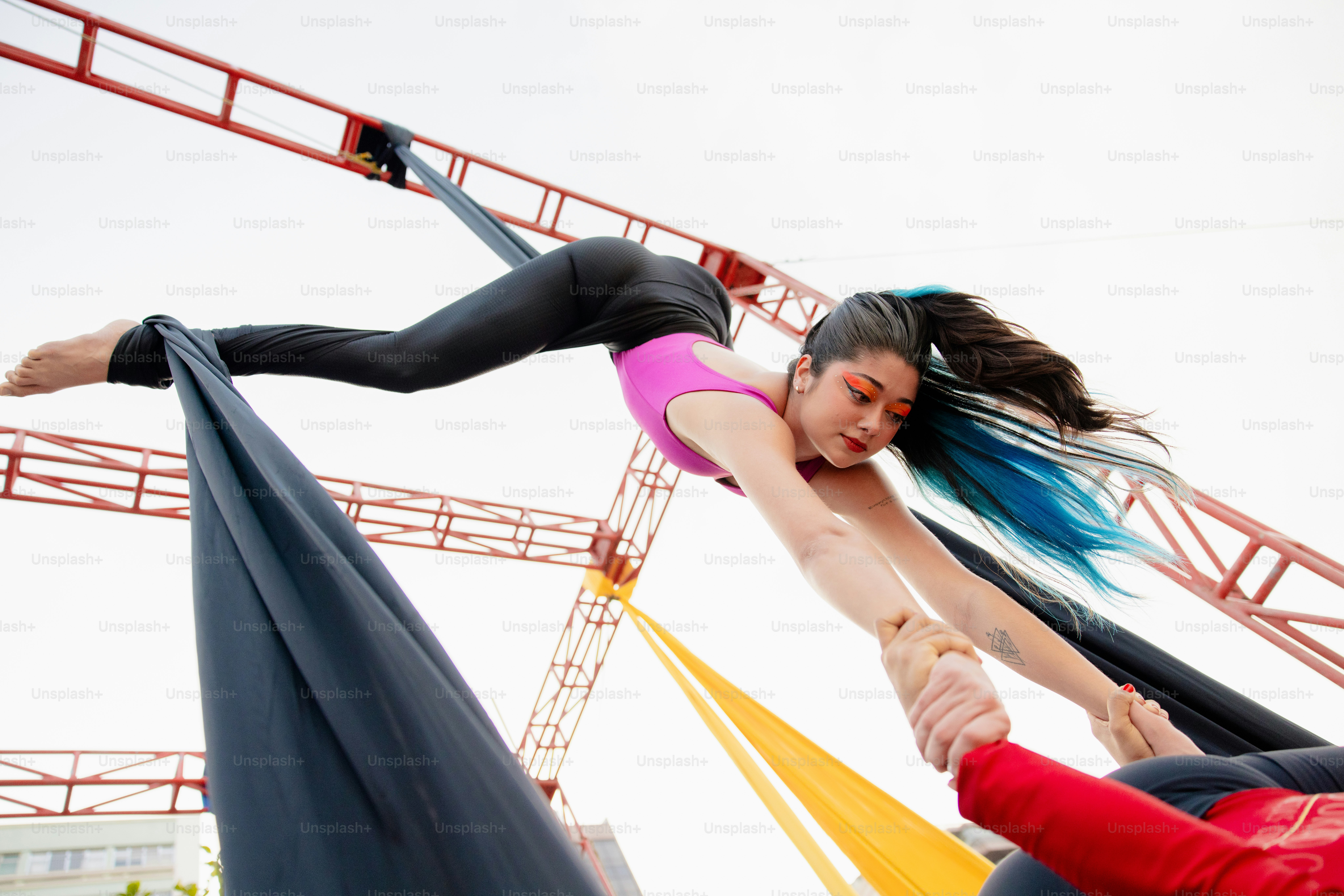 A couple of women standing on top of a pole