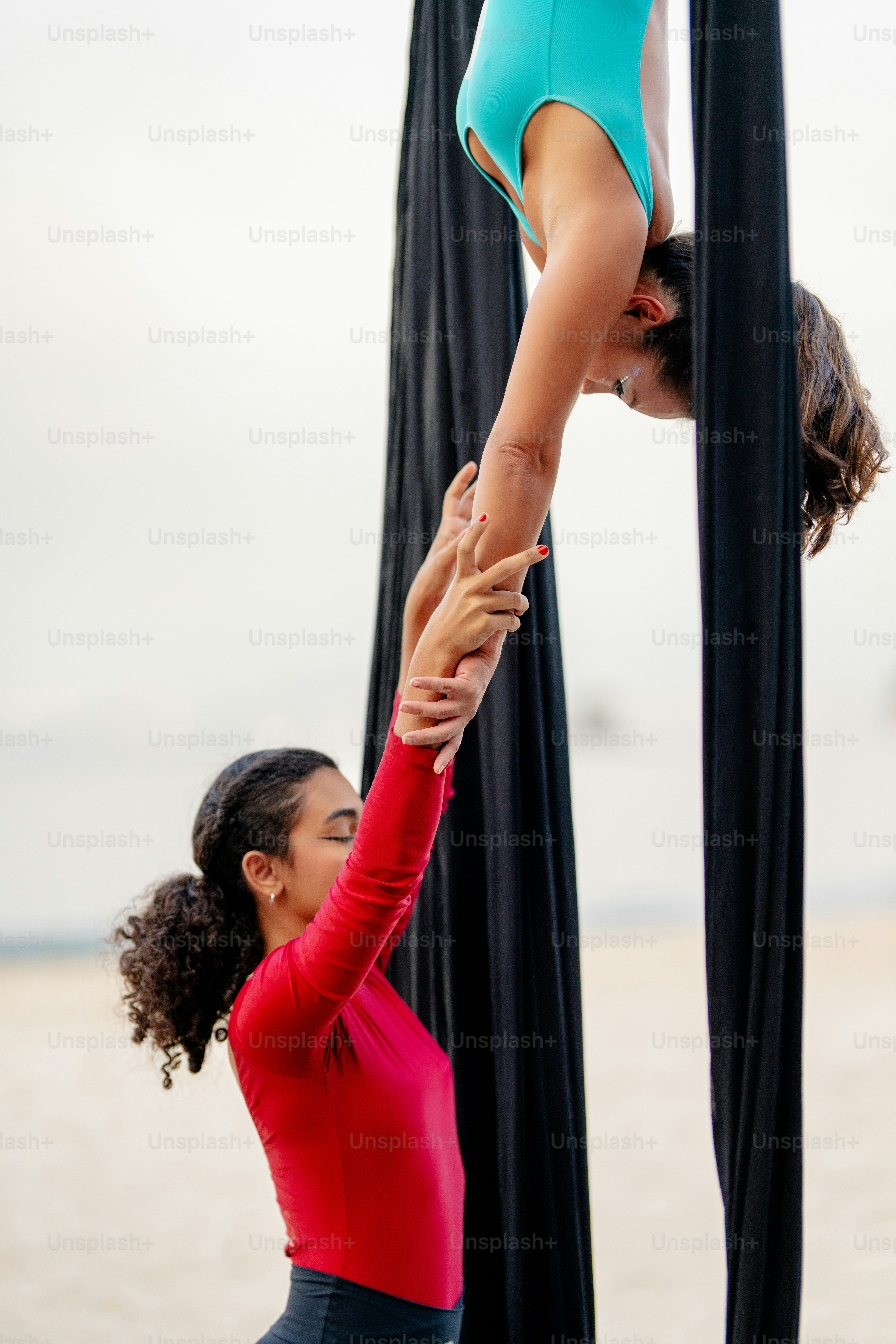 A woman doing a handstand on a pole