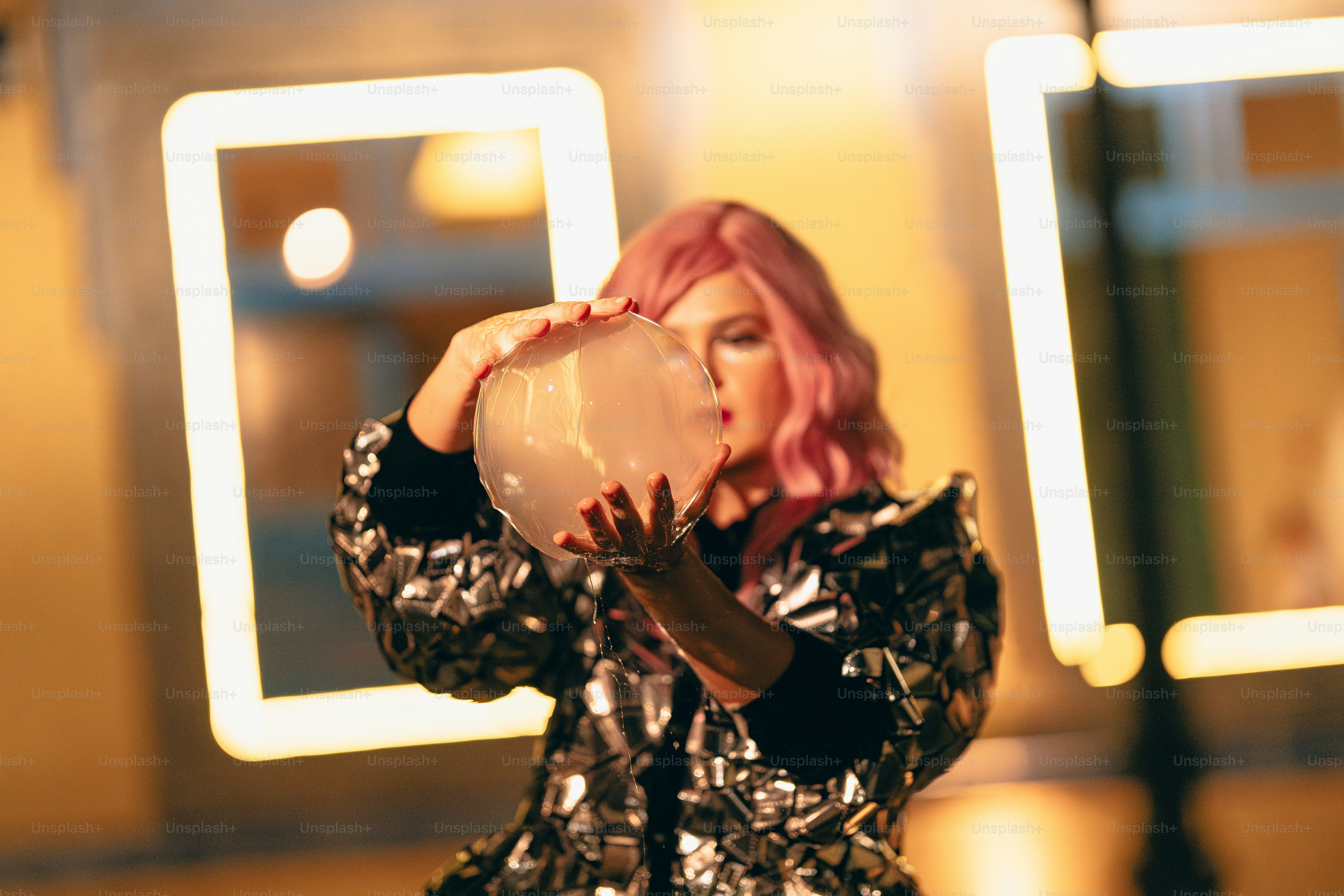 A woman with pink hair drinking from a cup