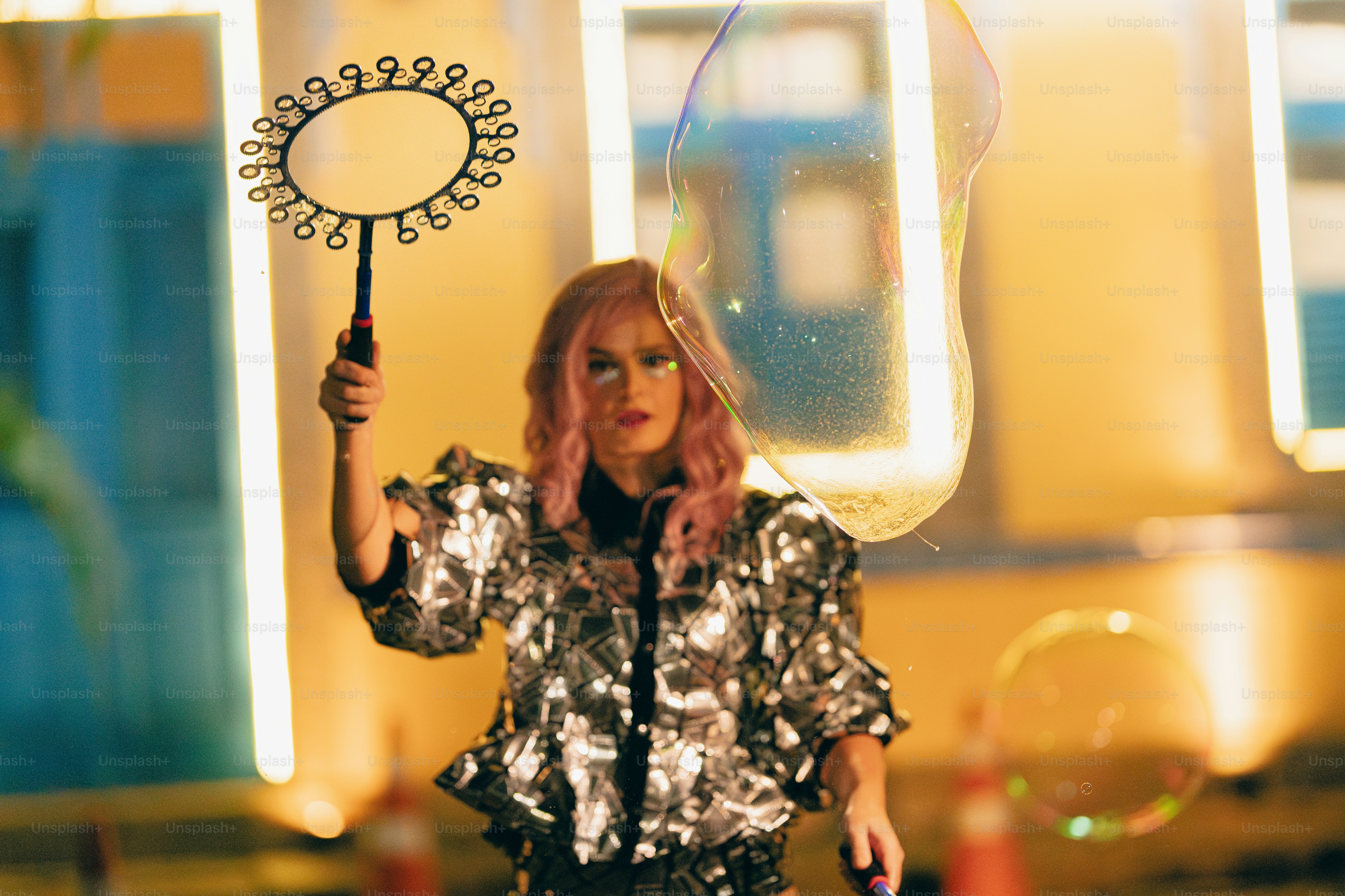 A woman in a silver dress holding a wand