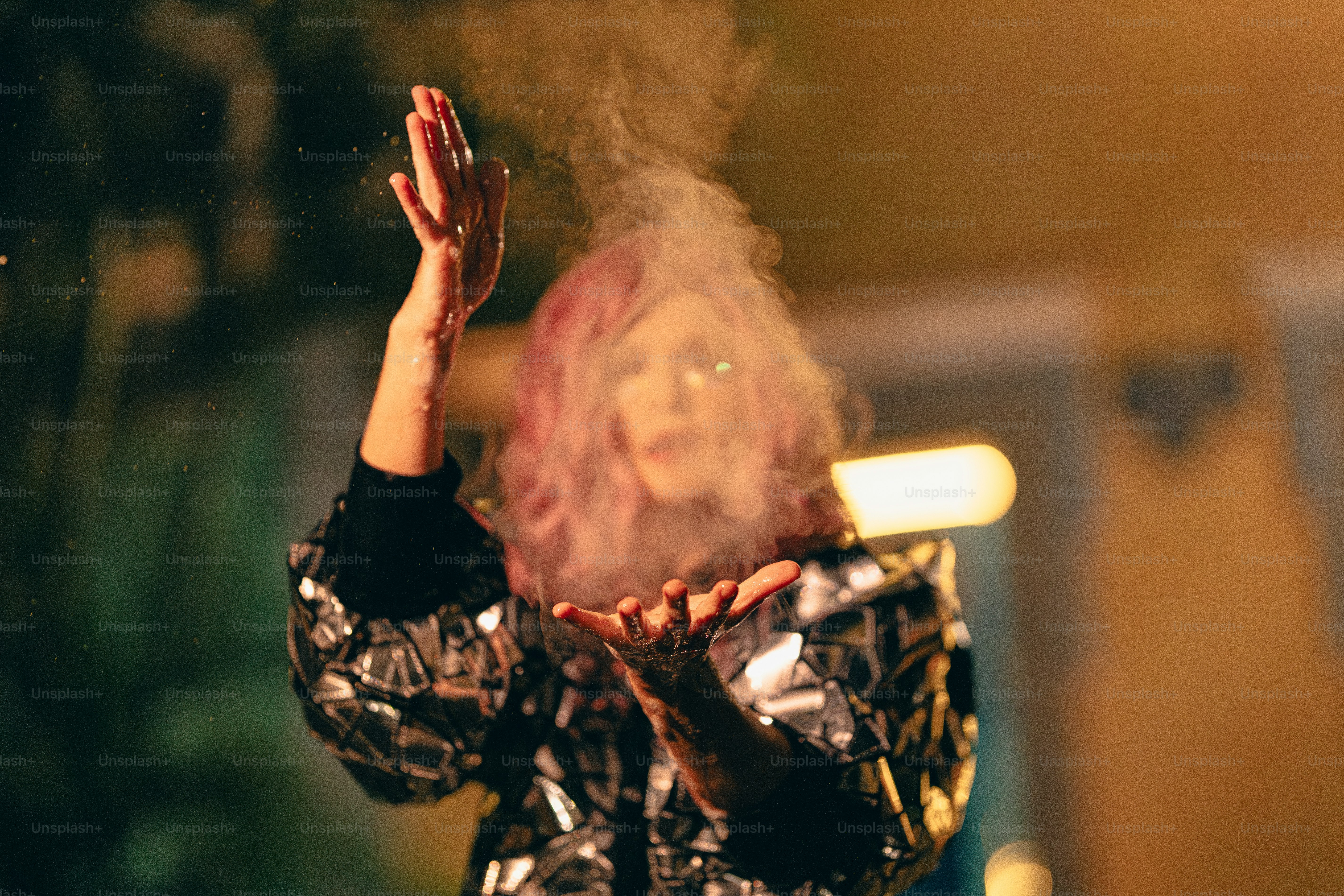 A woman holding her hands up in the air