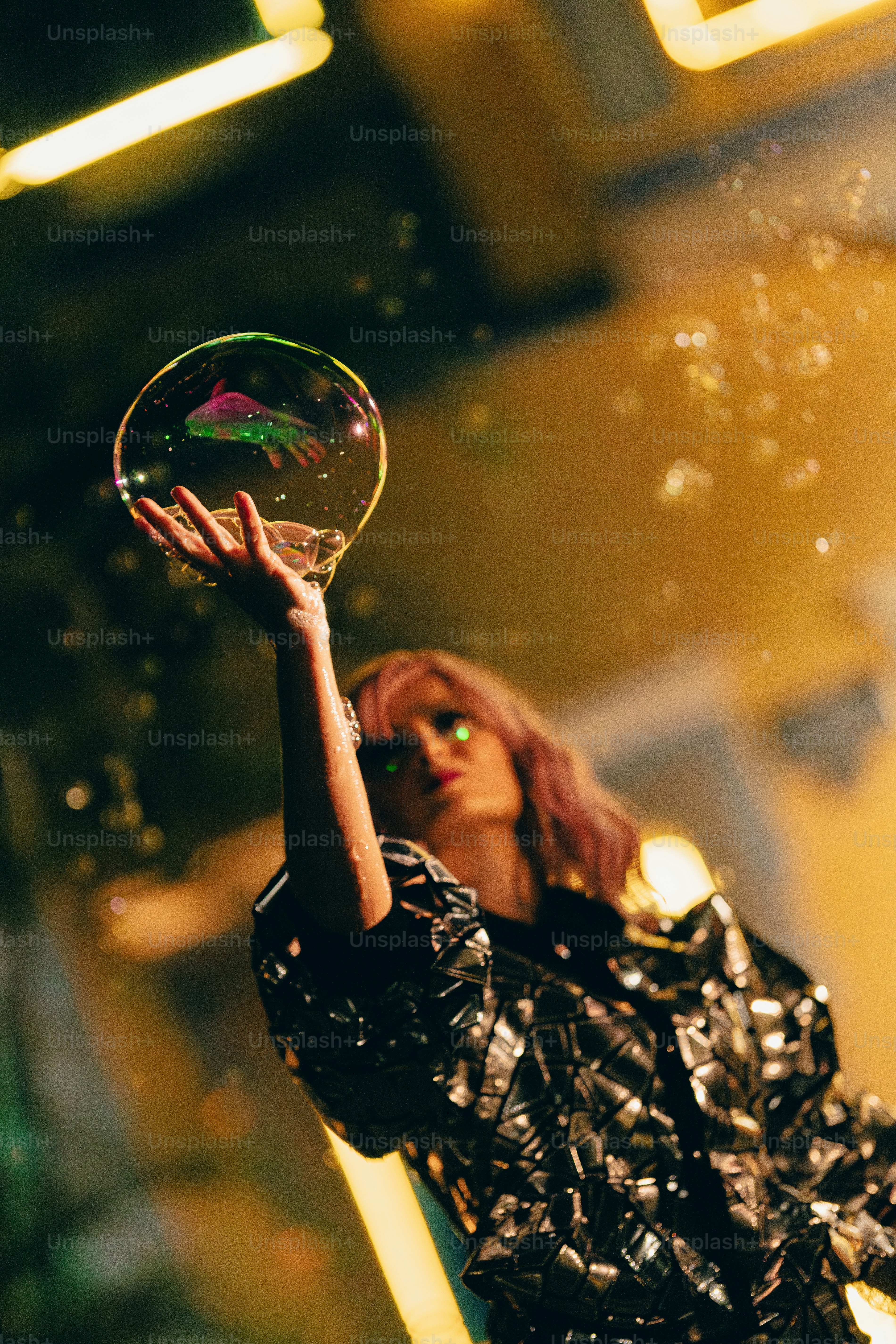 A woman is blowing bubbles in the air