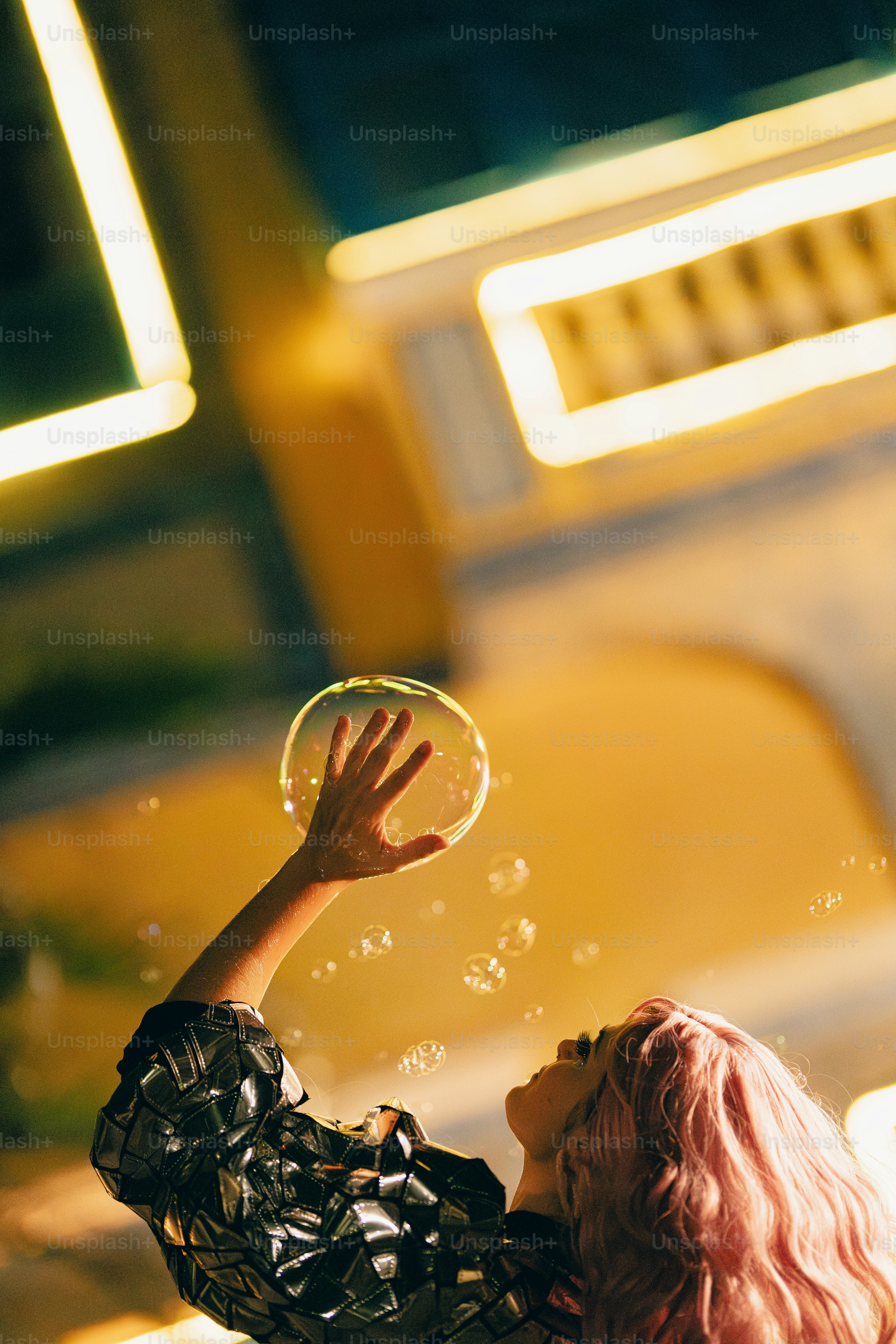 A woman is blowing bubbles in the air