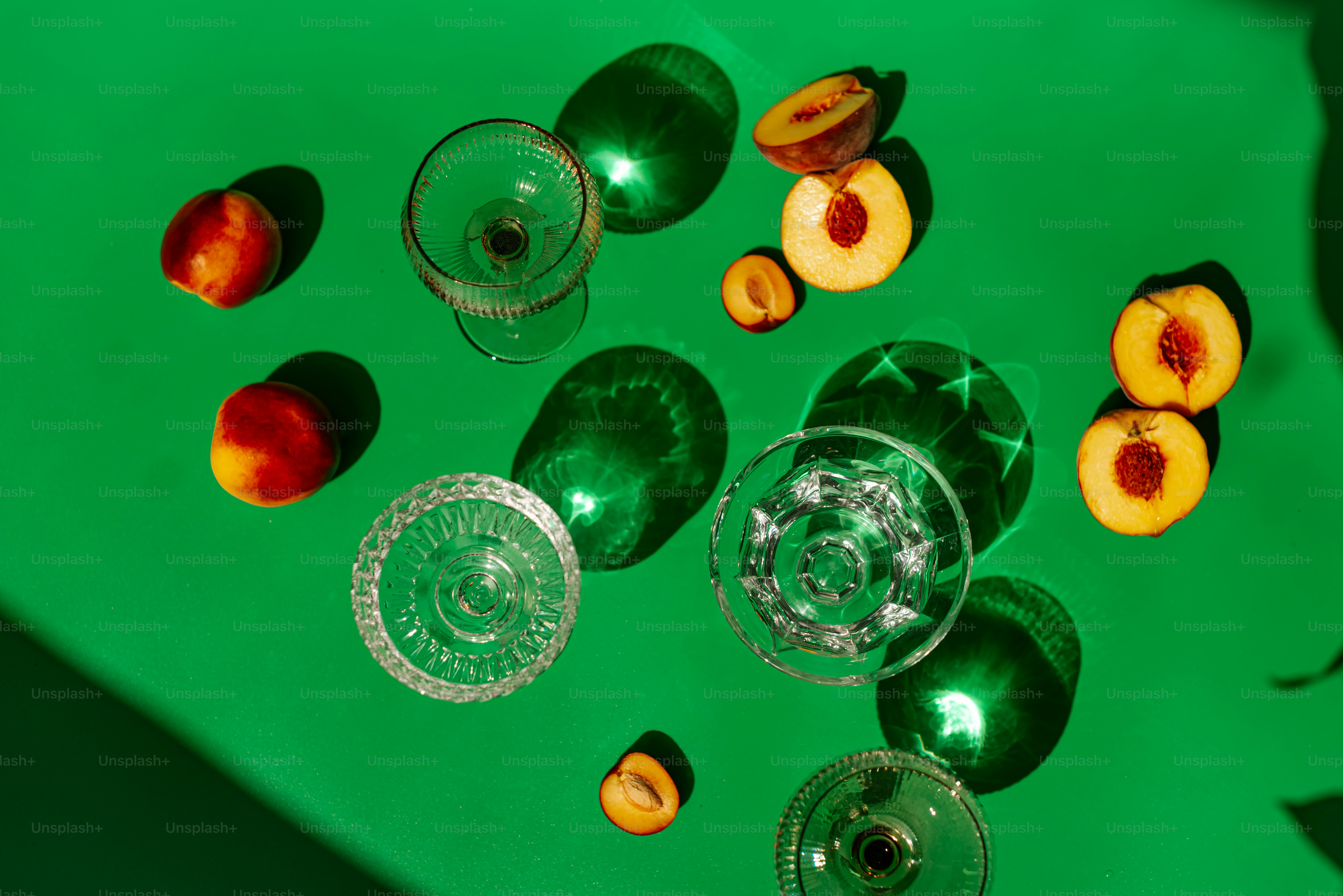 A green table topped with lots of wine glasses