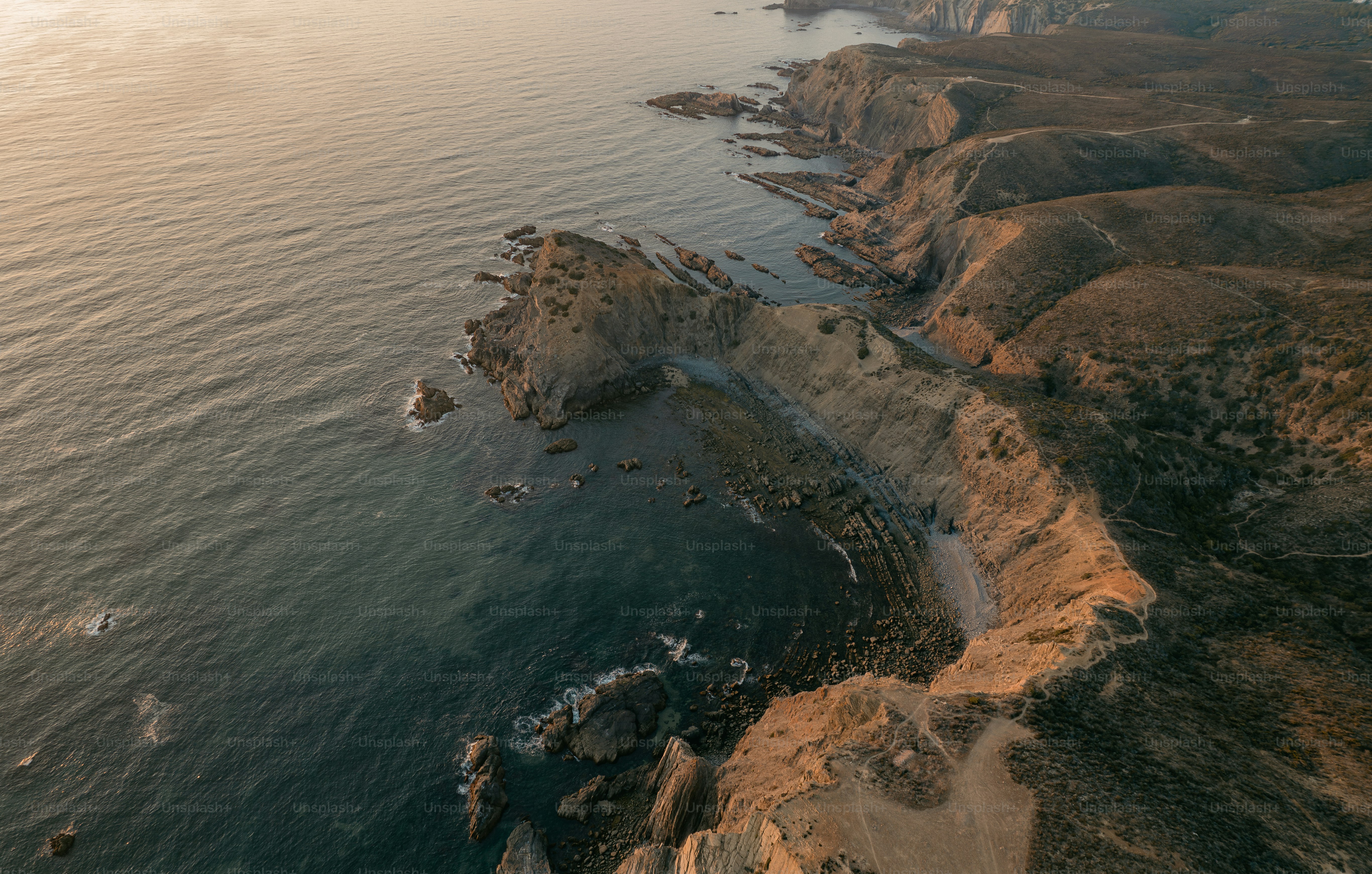An aerial view of the ocean and cliffs