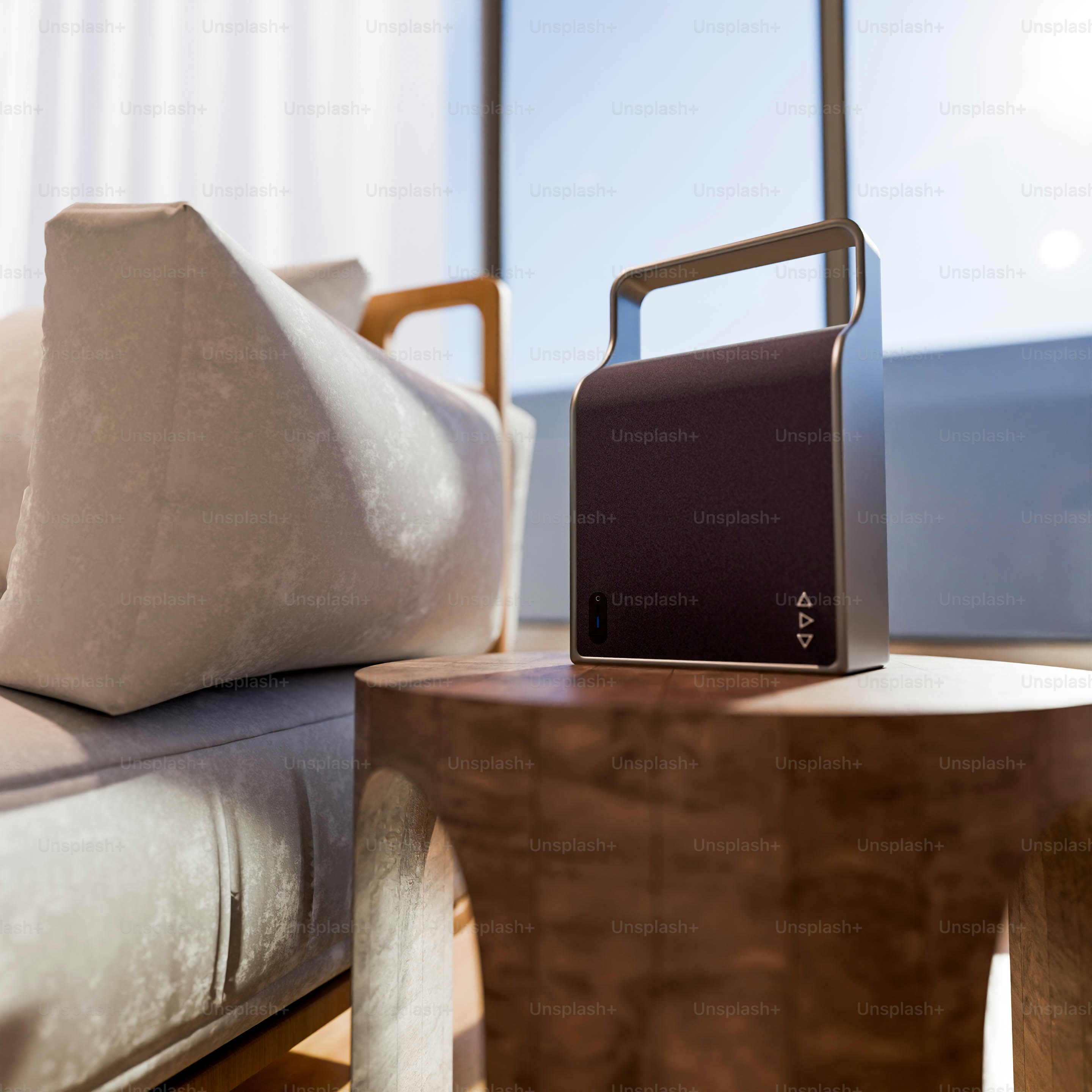 A table with a laptop on top of it next to a bed