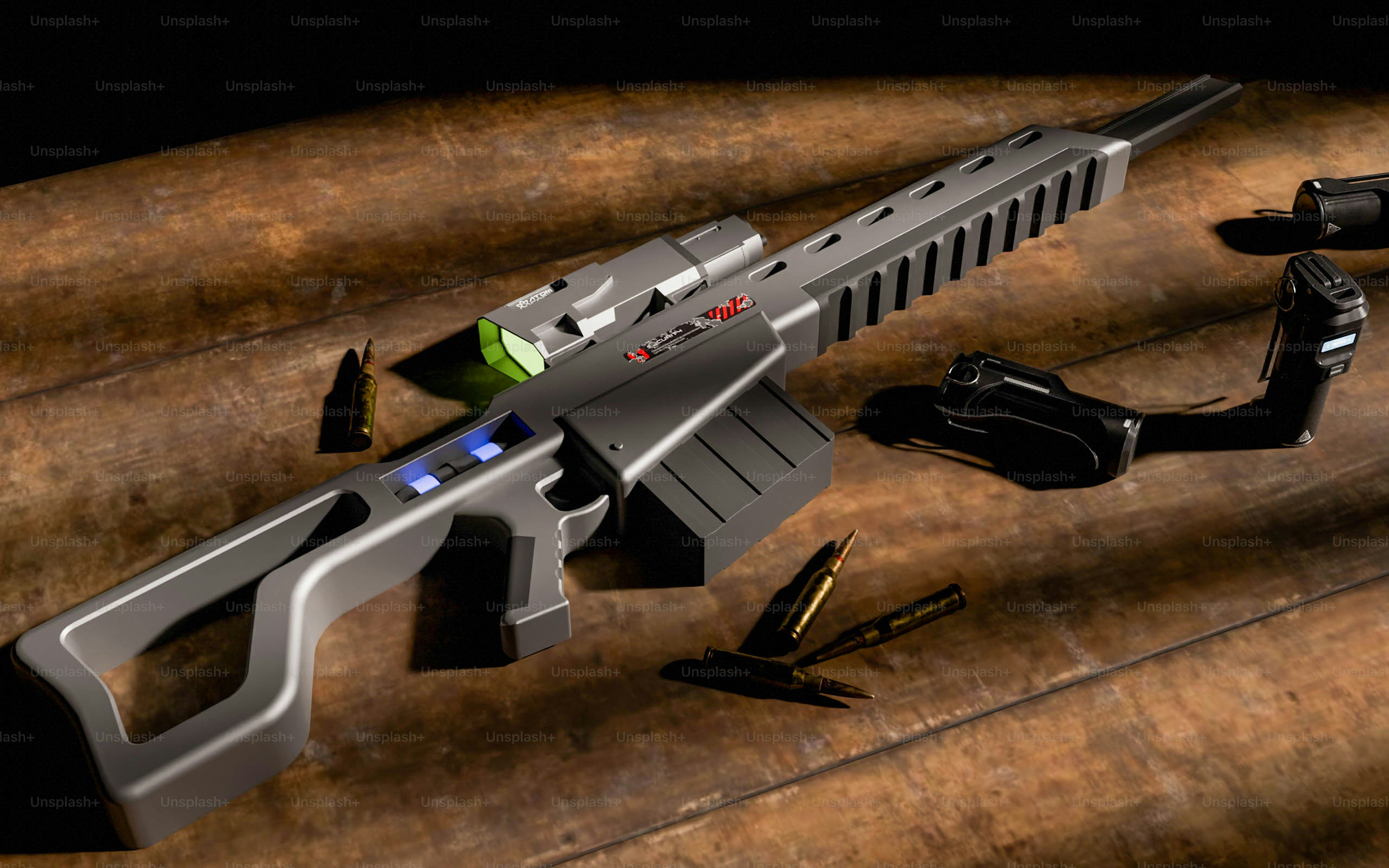 A futuristic gun and some other items on a table