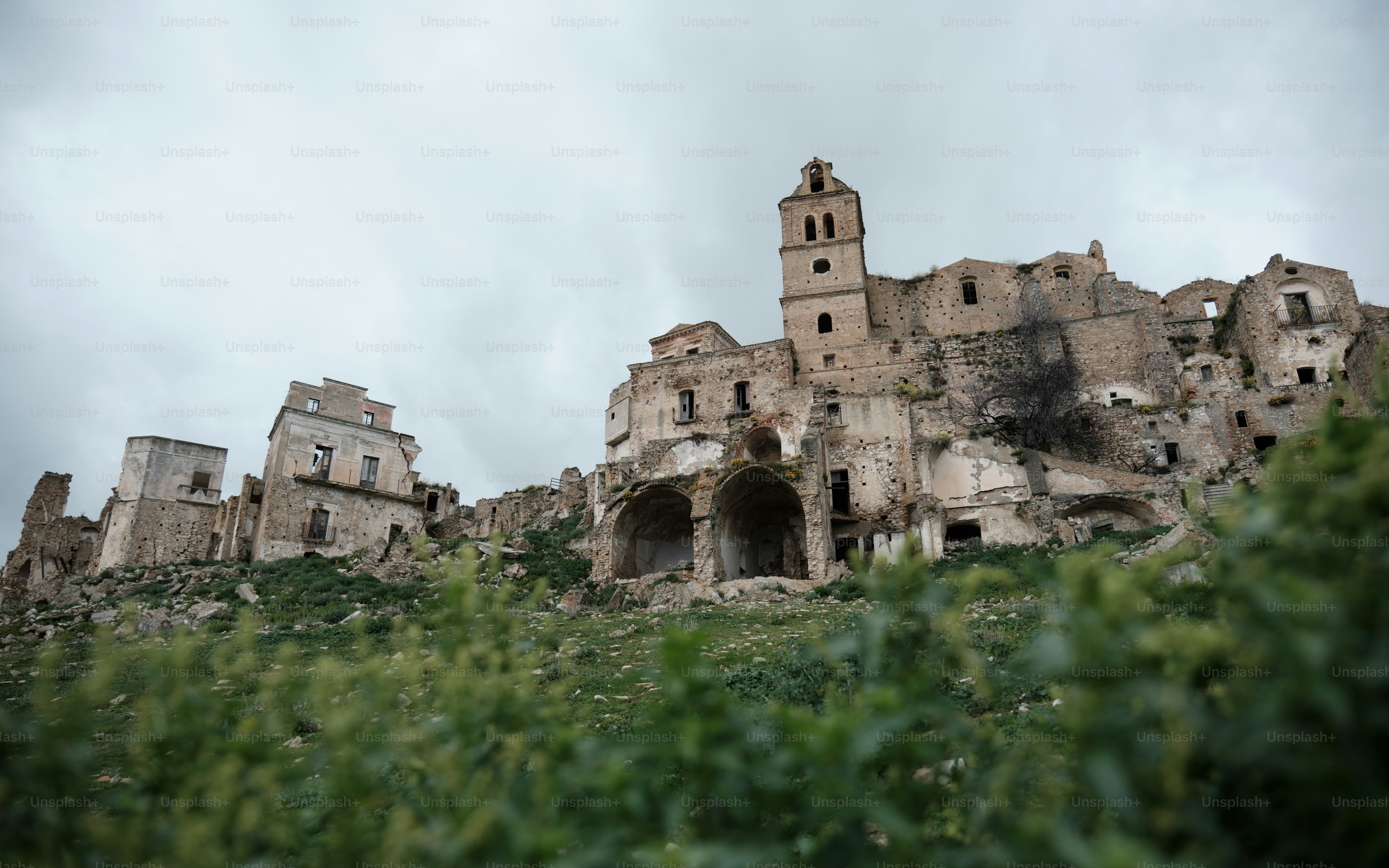 A large building sitting on top of a lush green hillside