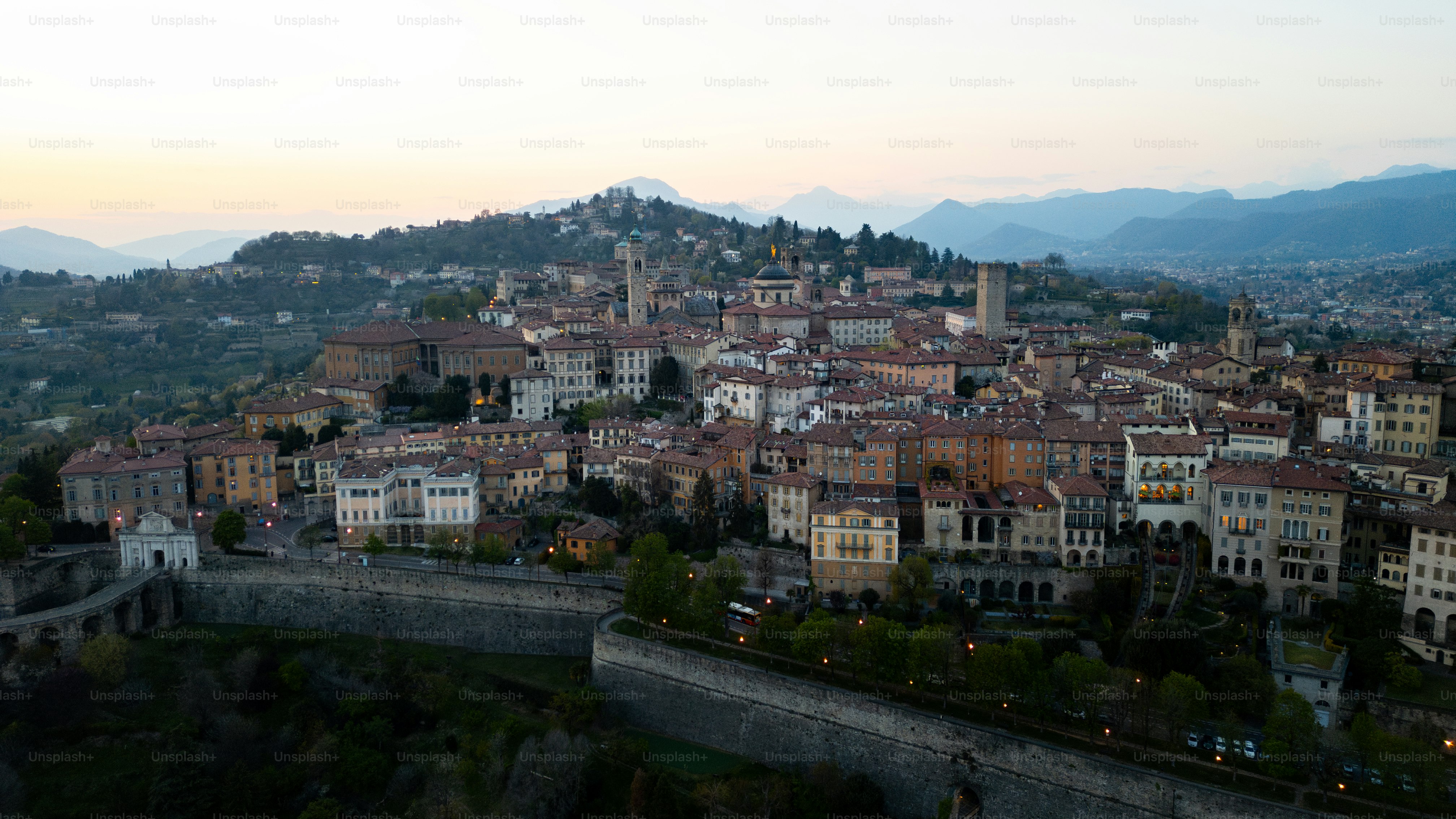 An aerial view of a city with mountains in the background