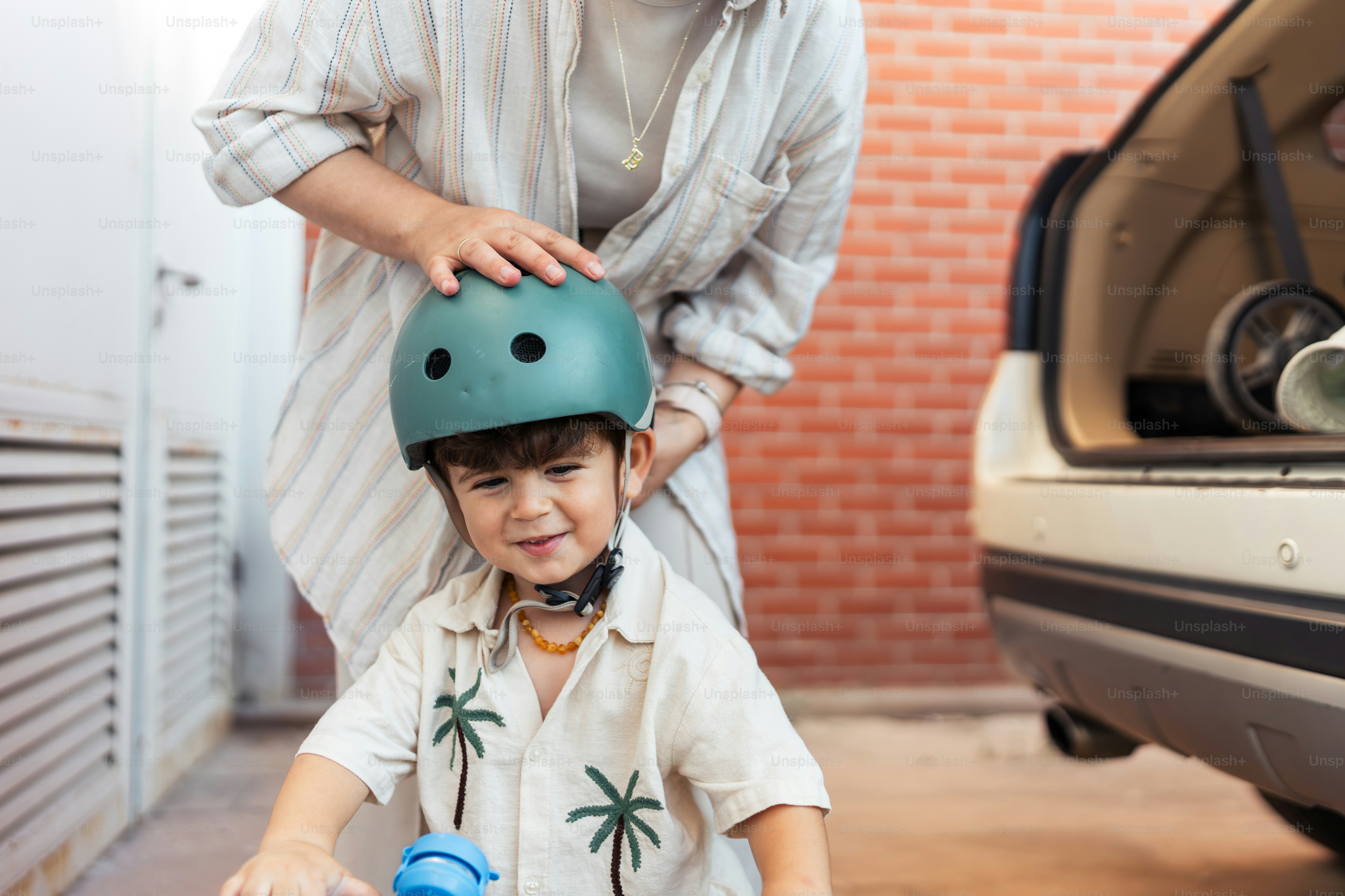 A little boy riding a scooter next to a man