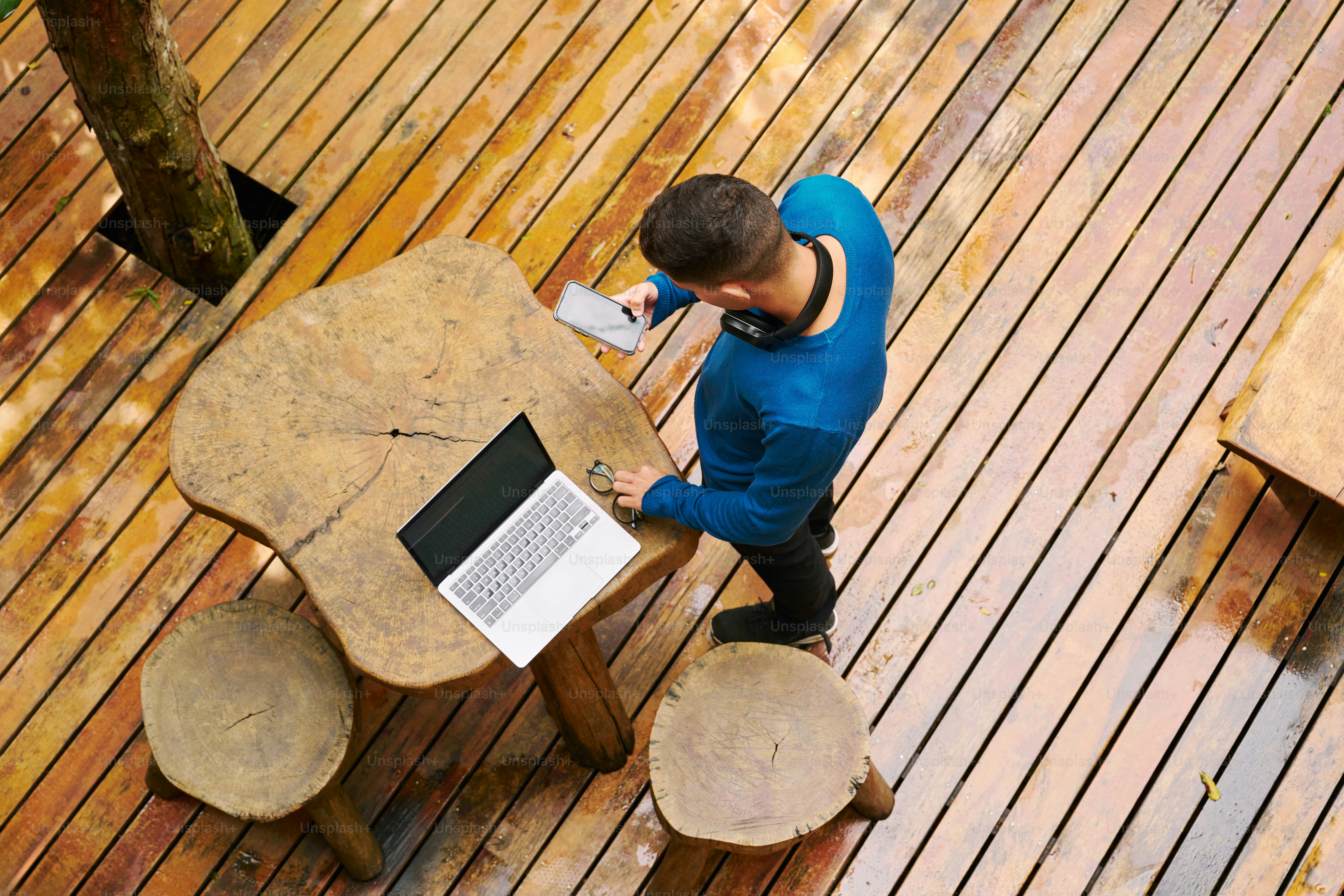 A man sitting at a table using a laptop computer