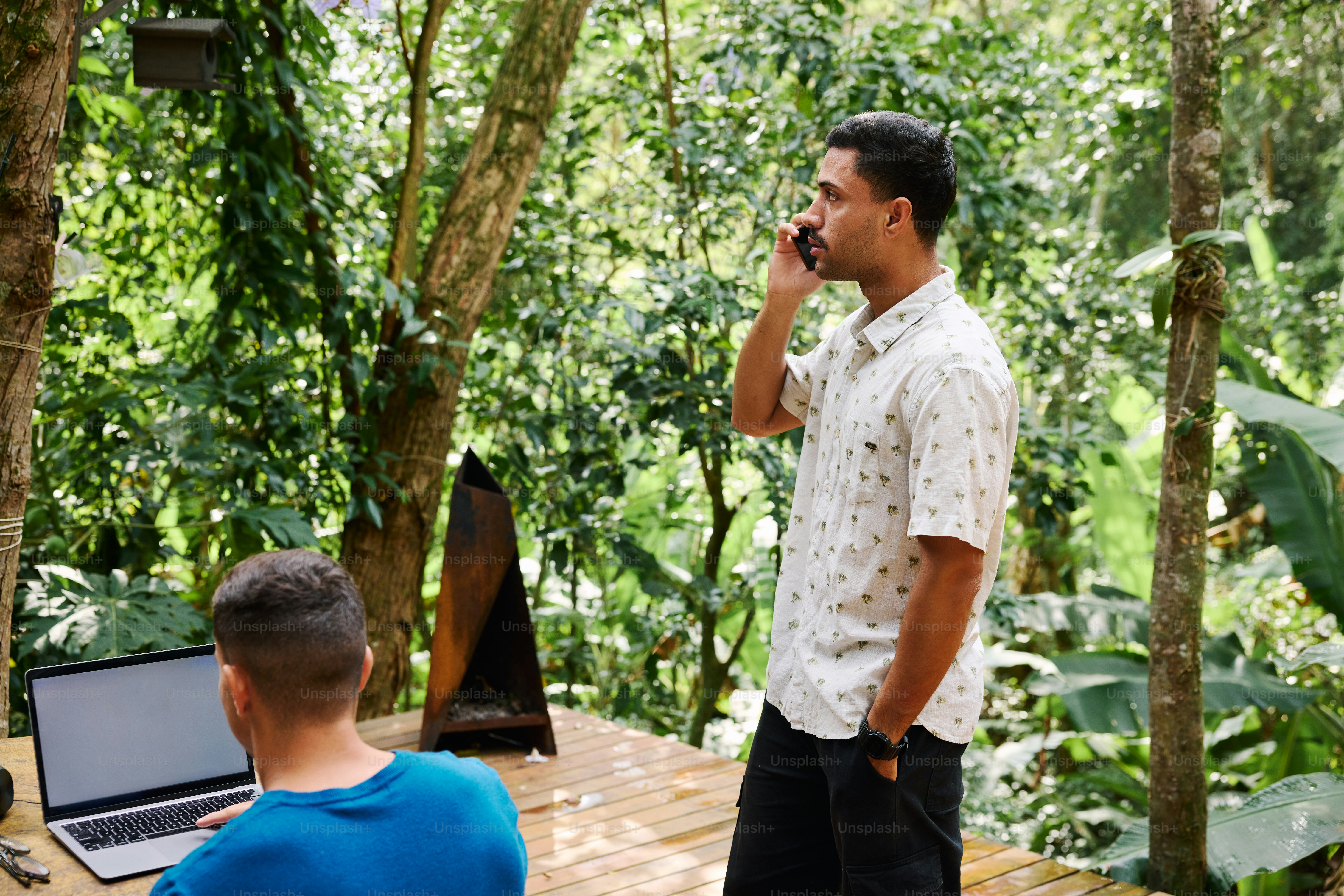 A man standing in front of a laptop computer