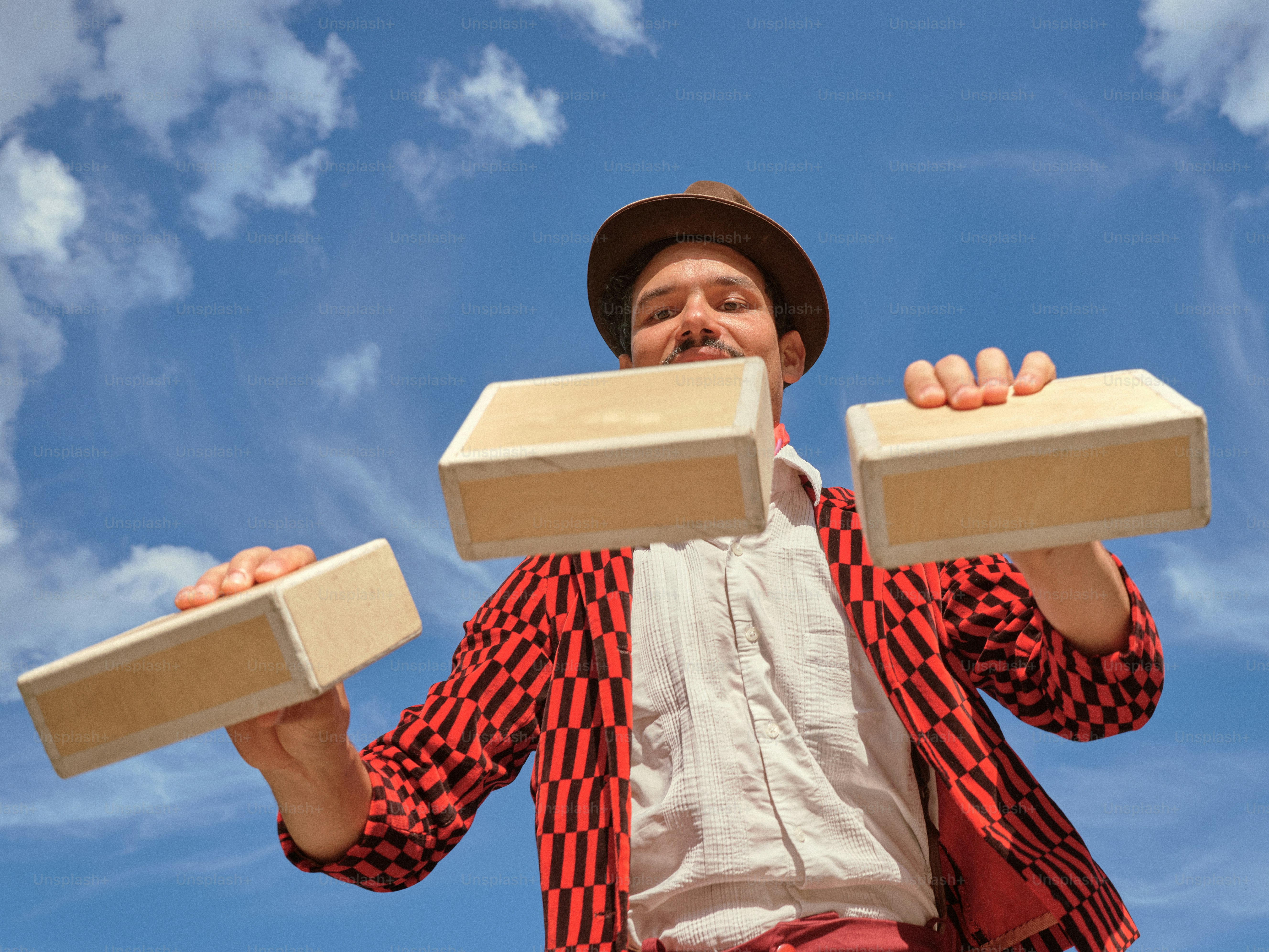 A man holding two blocks of wood in his hands