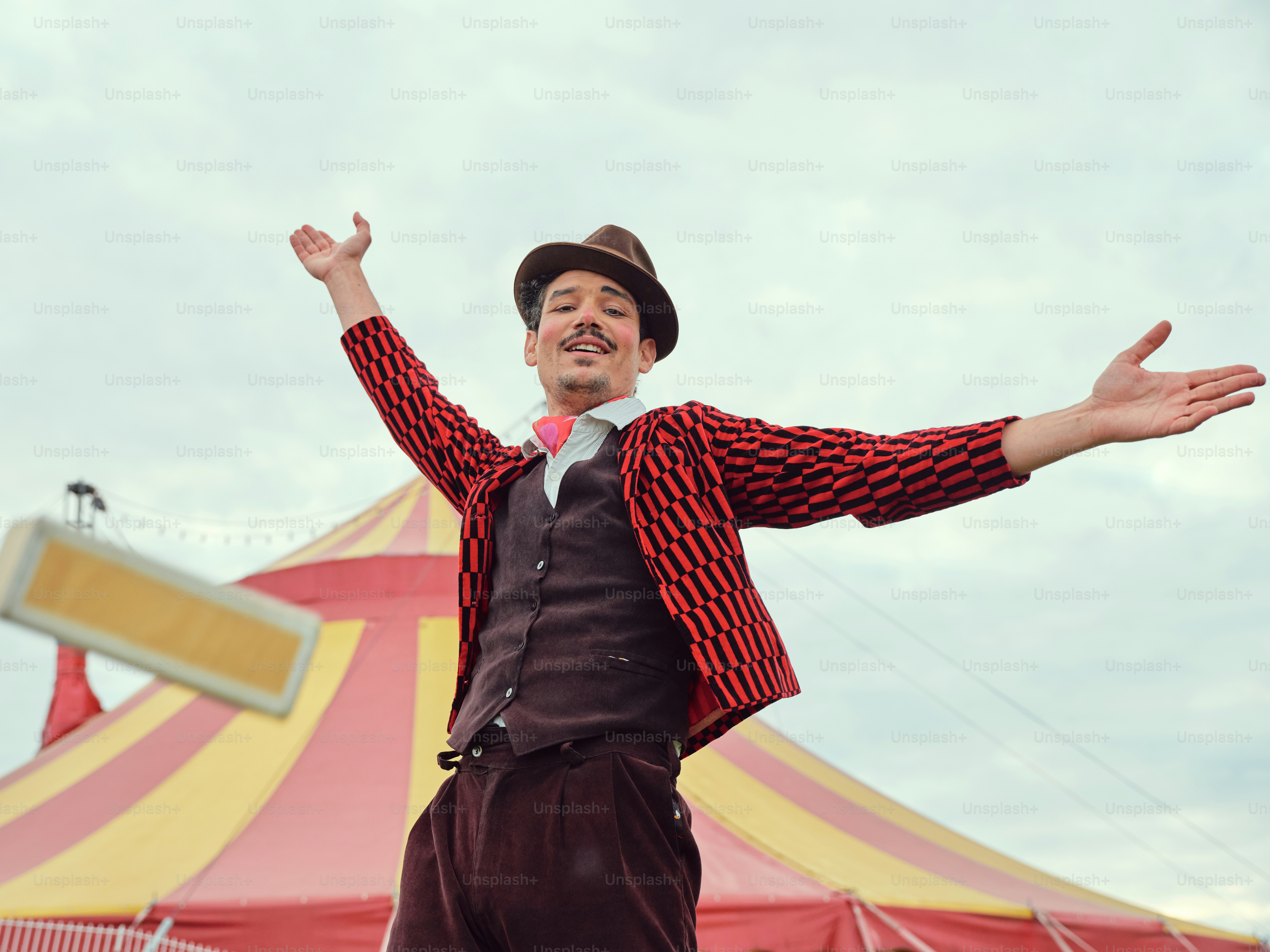 Ein Mann steht vor einem Zirkuszelt