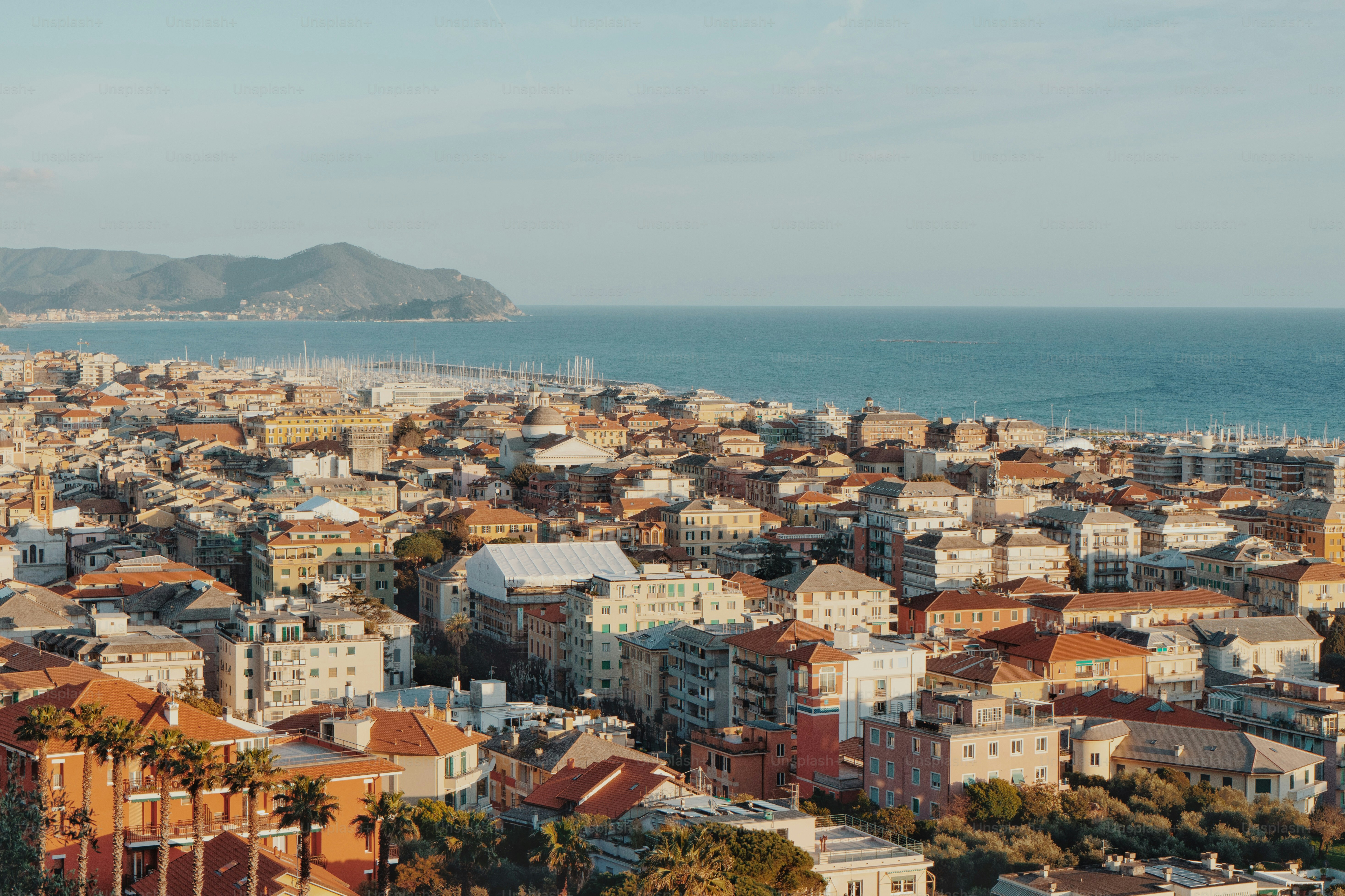 A view of a city with a body of water in the background